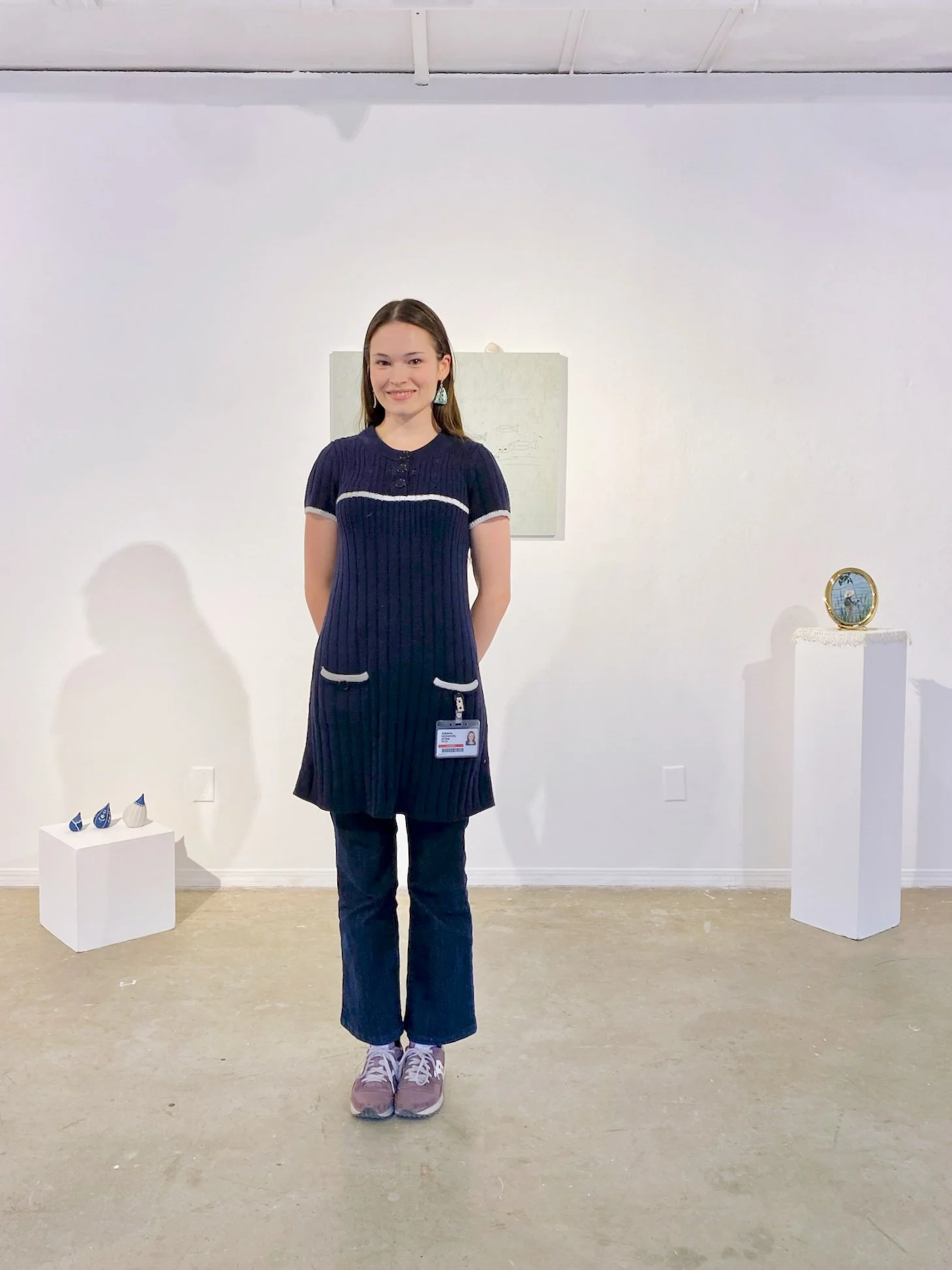 the artist (abalone shell earrings, navy-blue sweater dress, indigo-dyed jeans, purple saucony sneakers, AUArts keycard, smile) 5'5" in height