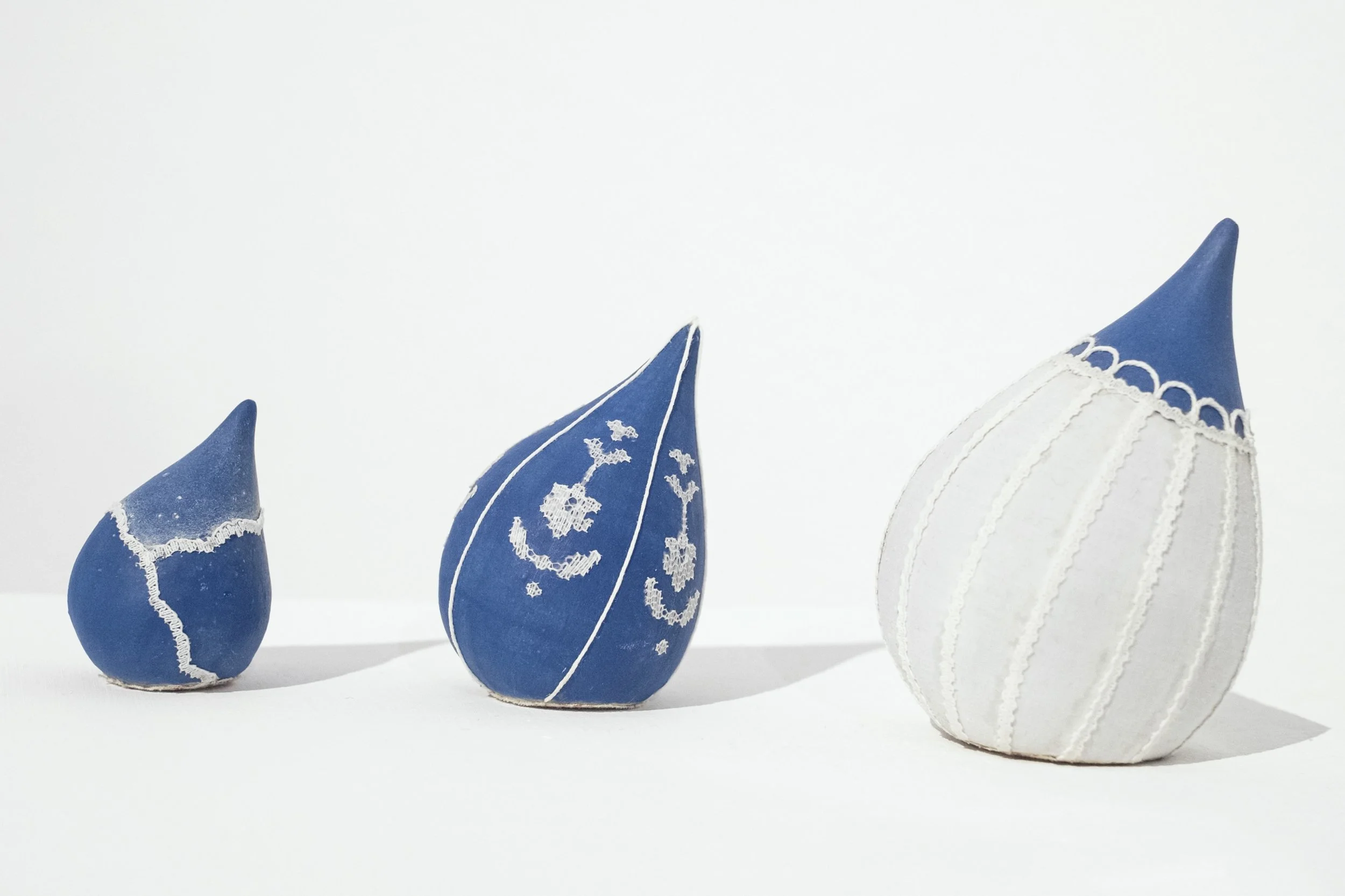 ceramic sculpture (stoneware, cotton fabric, cotton yarn, polyester lace, pencil crayon) 2", 3", and 4" in height
