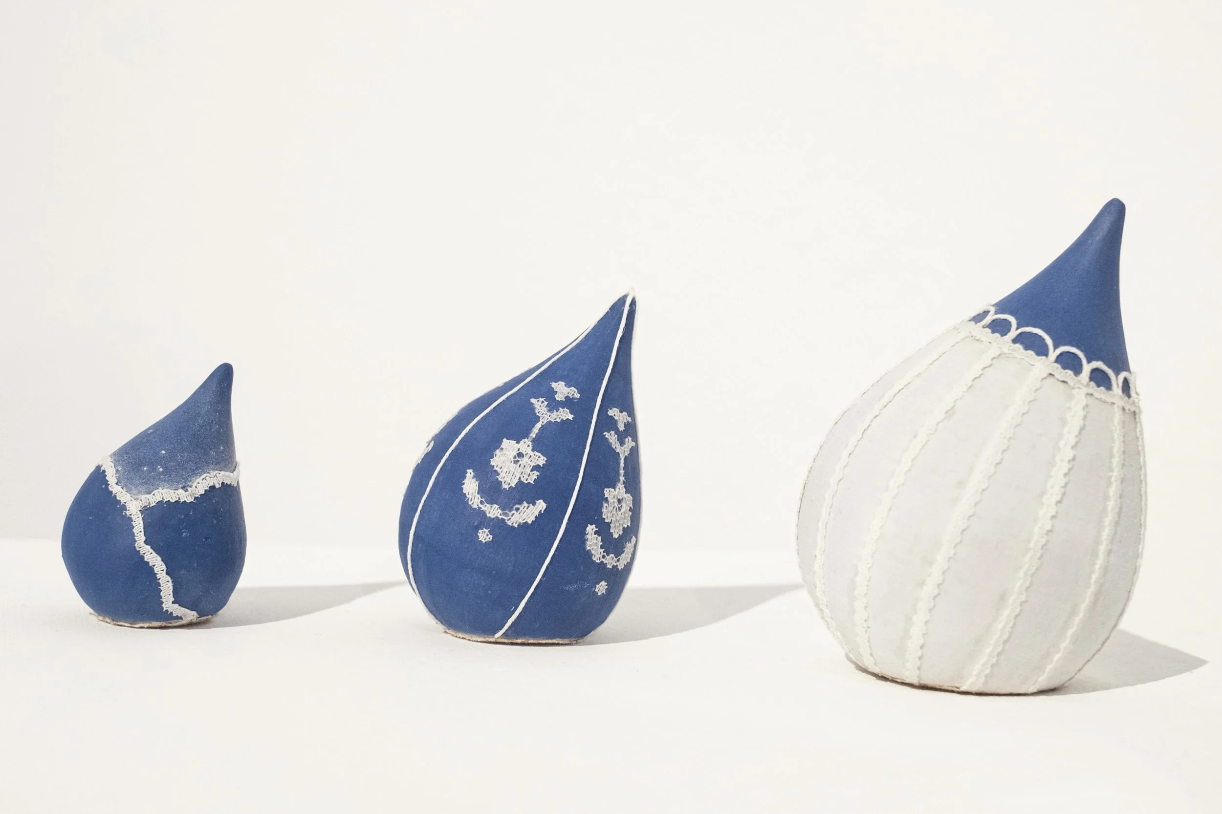 ceramic sculpture (stoneware, cotton fabric, cotton yarn, polyester lace, pencil crayon) 2", 3", and 4" in height