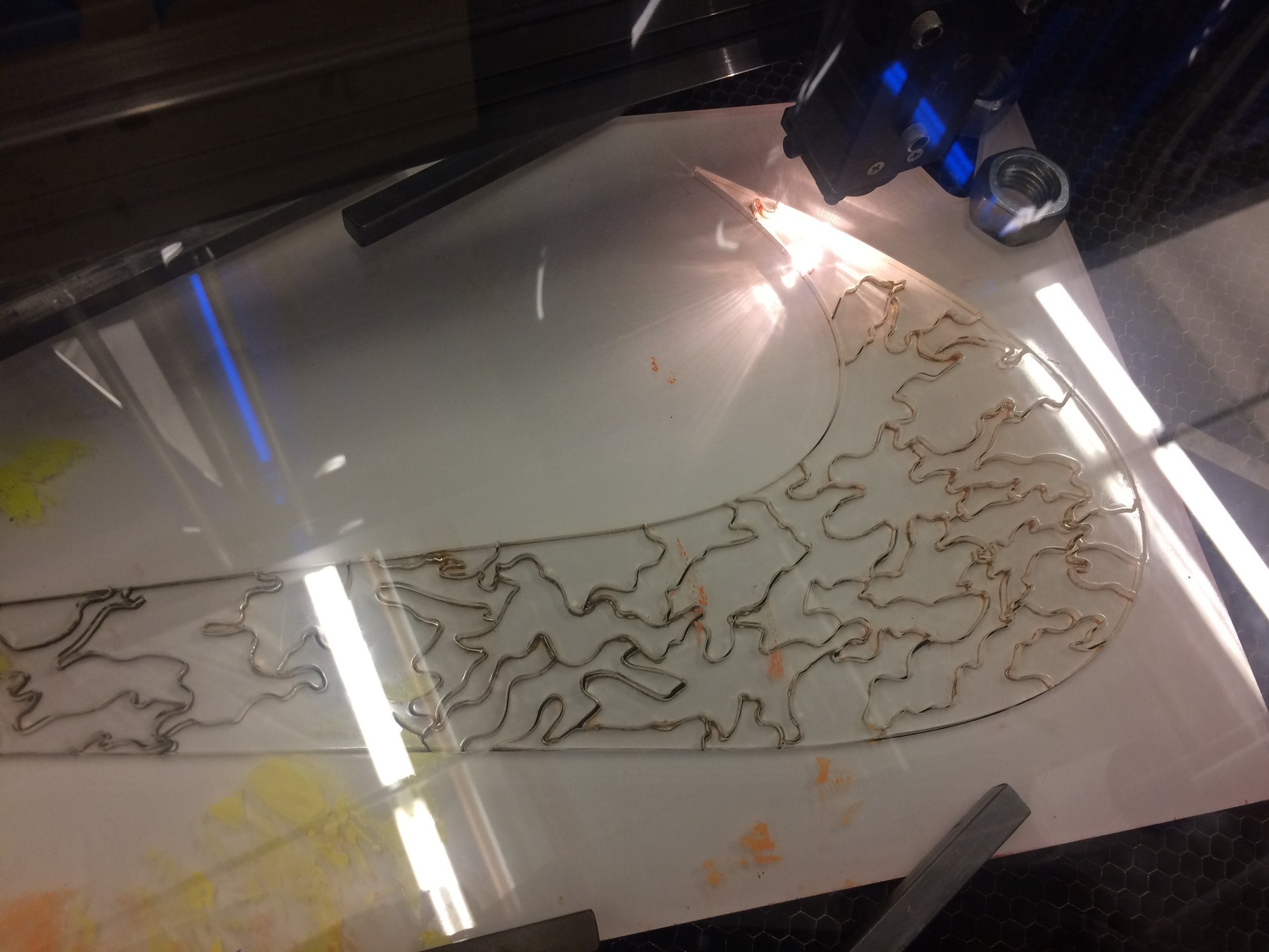 Transparent acrlyic nike swoosh puzzle in lasercutting process
