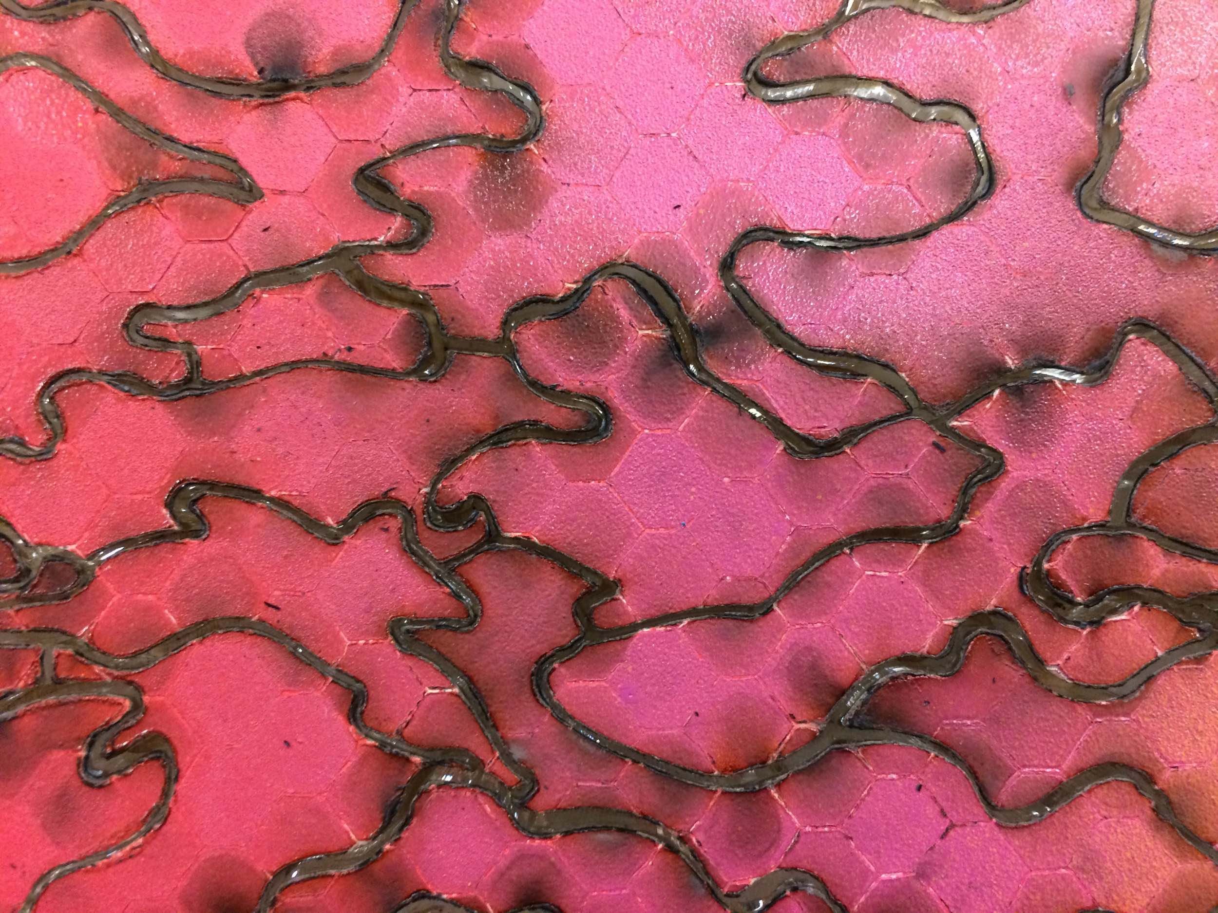 Detail of pink nike swoosh acrylic puzzle with lasercut outlines