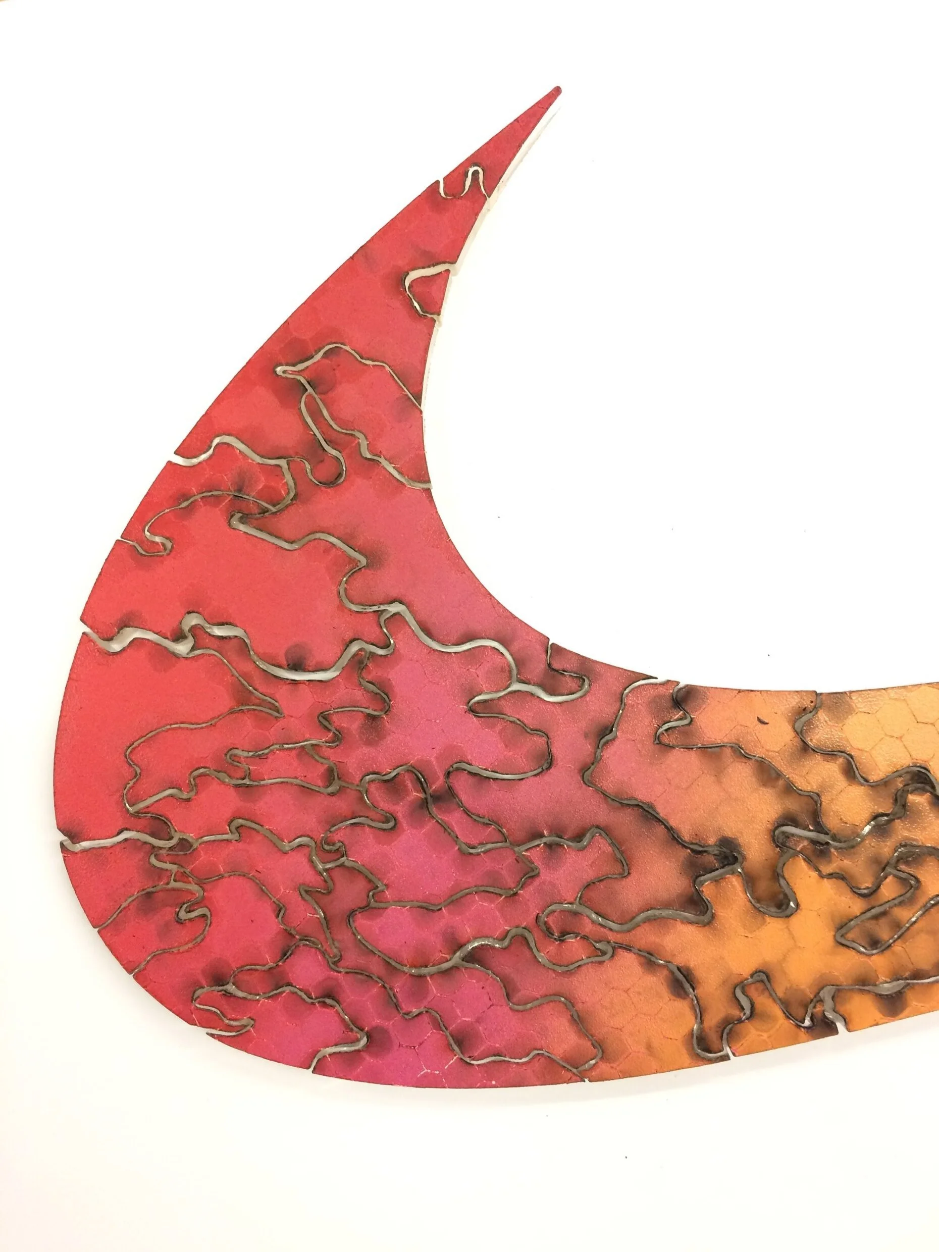 Left curve of nike swoosh puzzle sculpture on white background