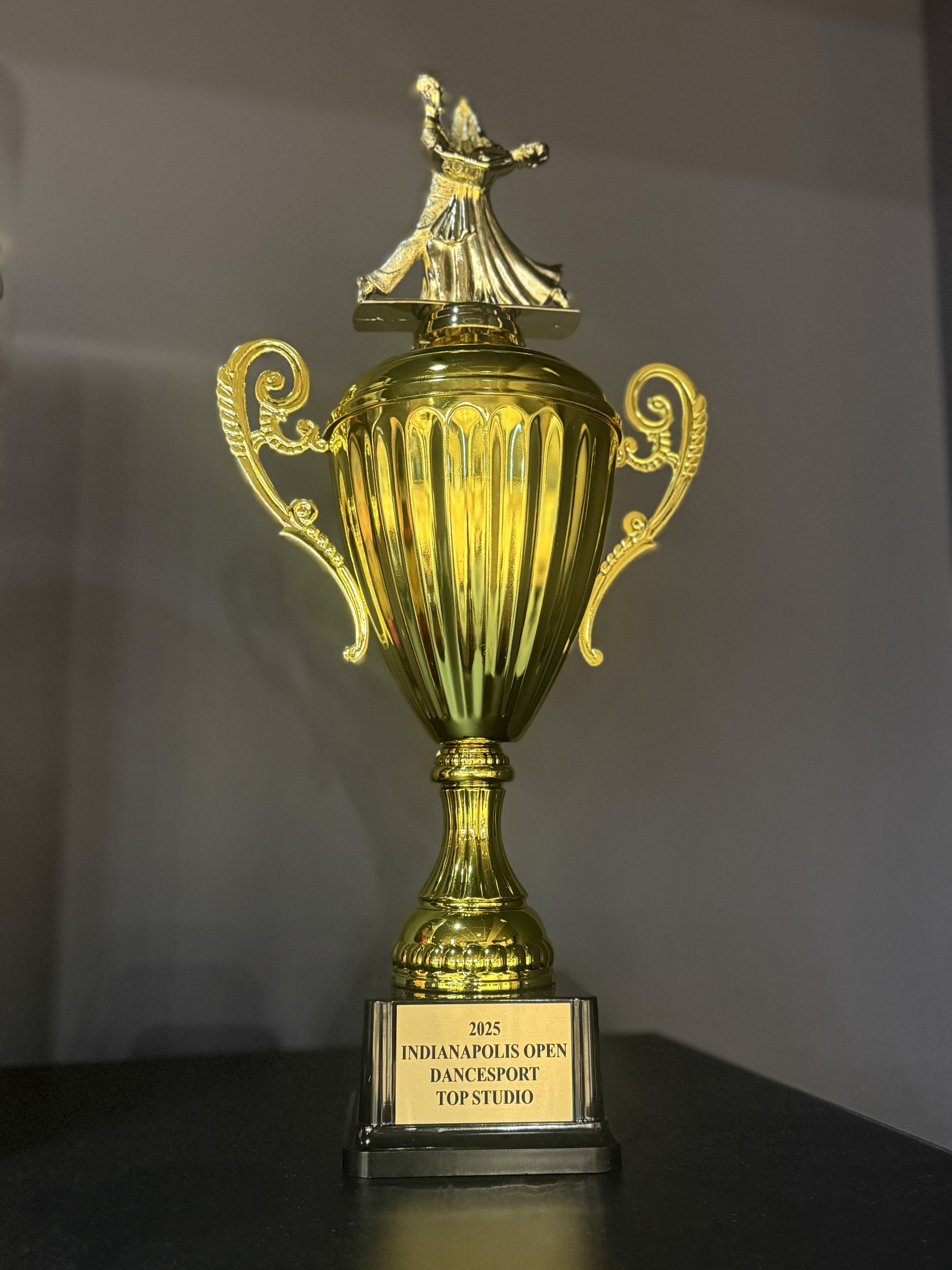 Gold trophy with dancer figurine, labeled "2025 Indianapolis Open Dancesport Top Studio."