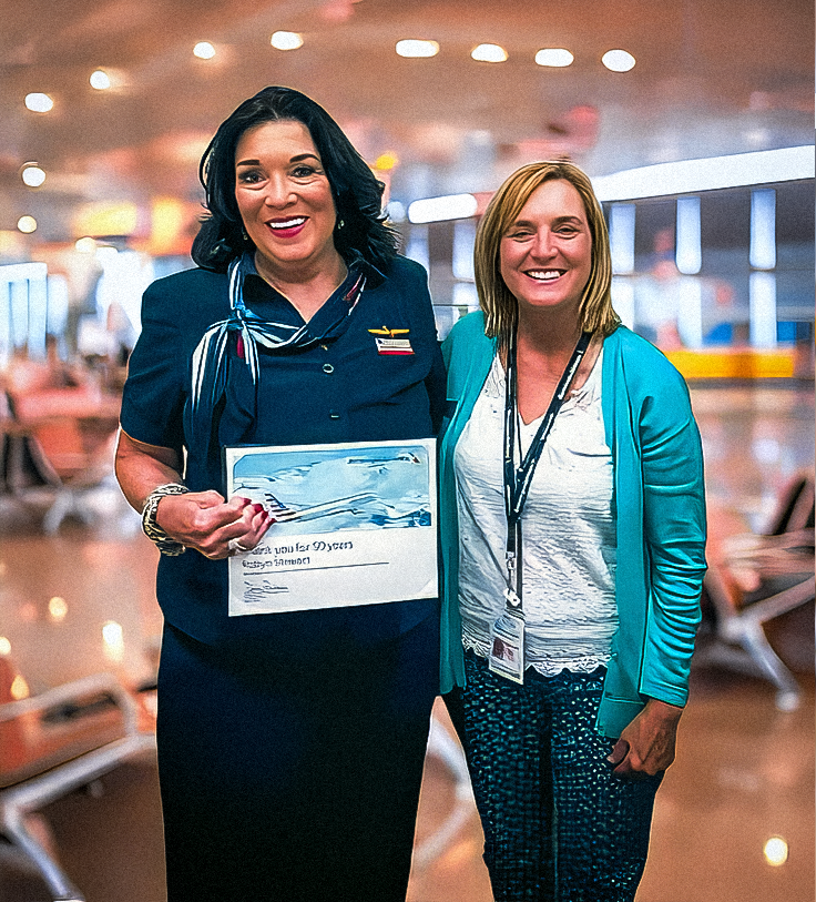 Robyn Stewart with her supervisor receiving commemorative certifacate For 50 years of service with American Airlines
