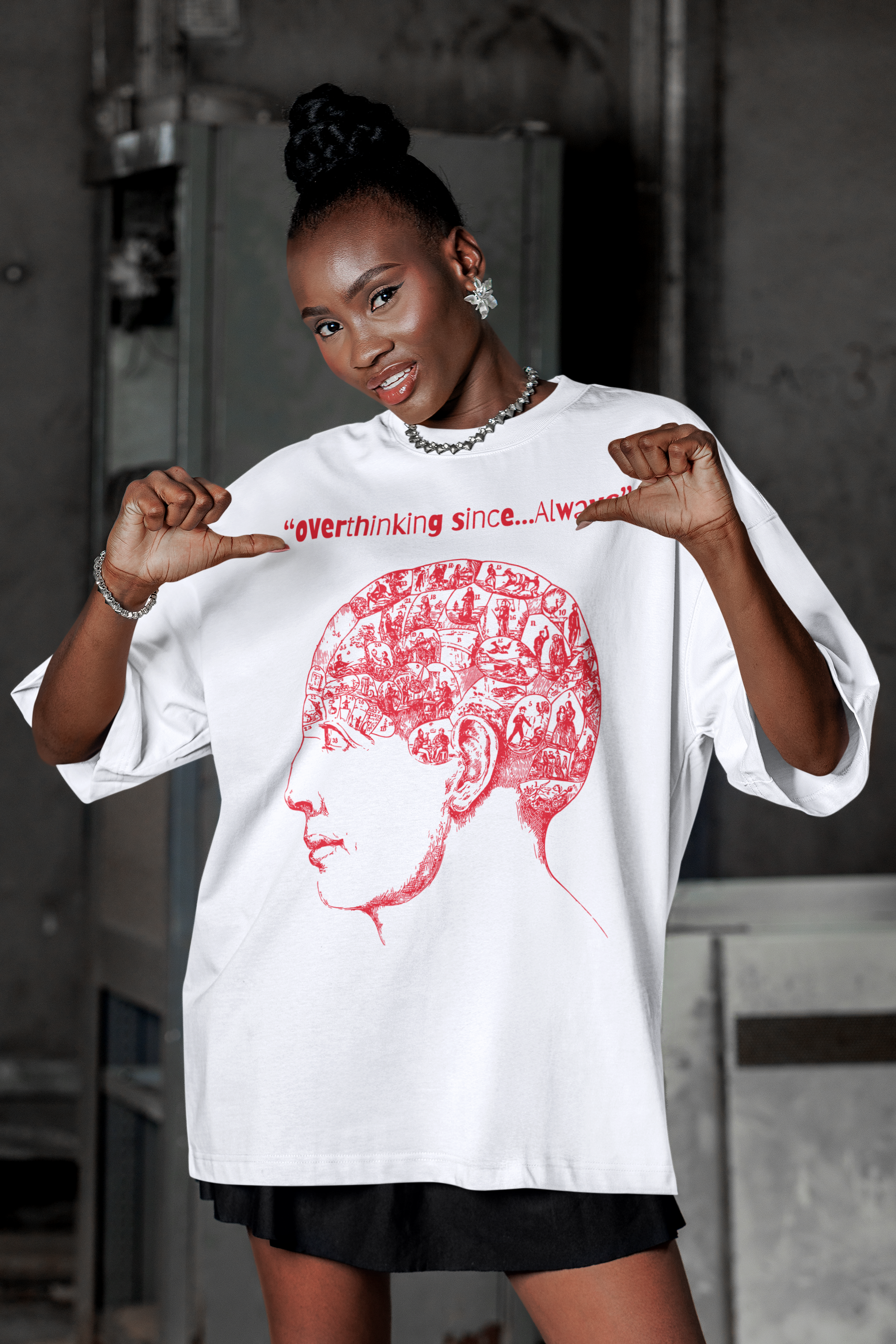 mockup-of-a-woman-pointing-at-her-oversized-t-shirt-while-posing-in-a-parking-lot-m55878 (1).png