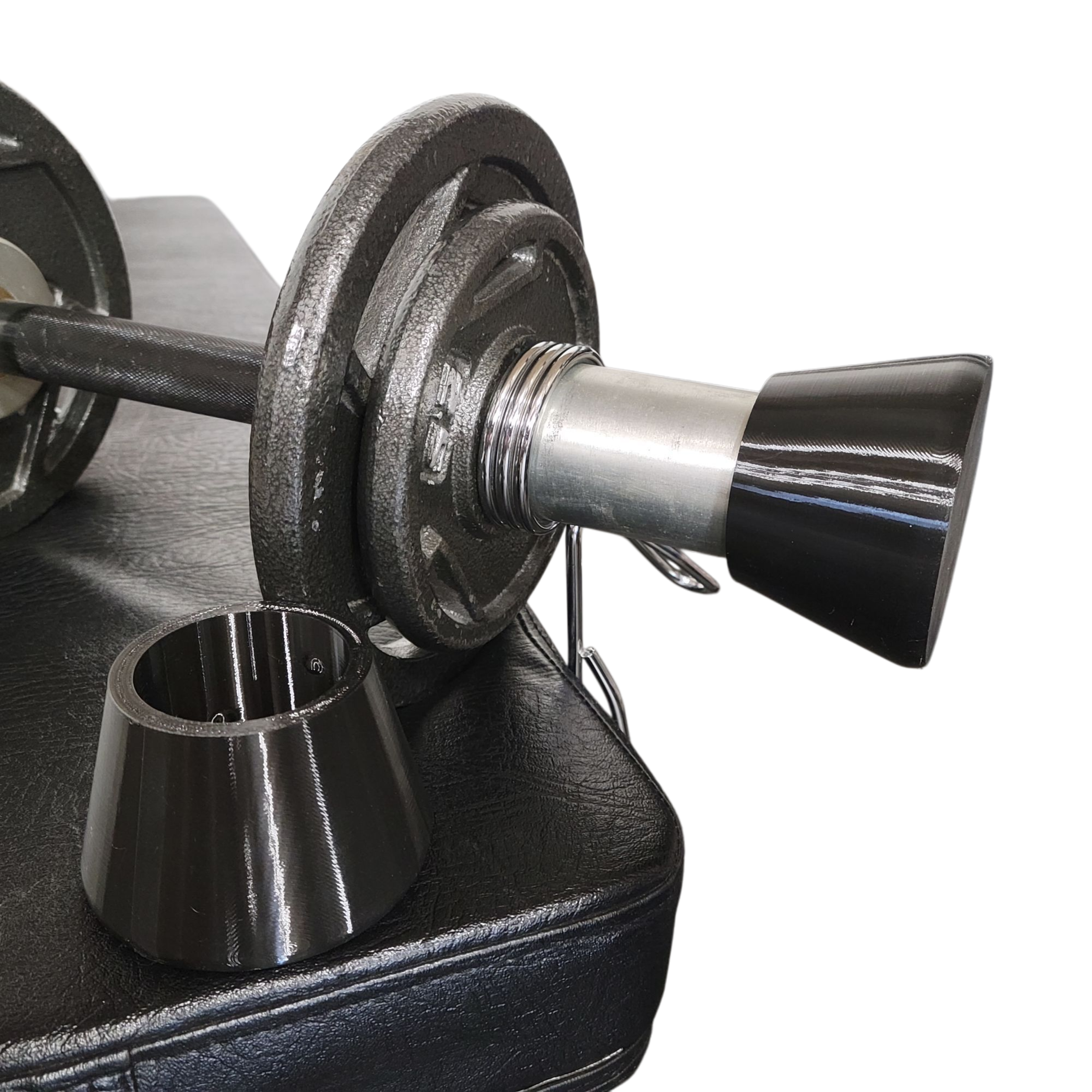 black plastic caps and olympic dumbbells with weight plates sitting on bench