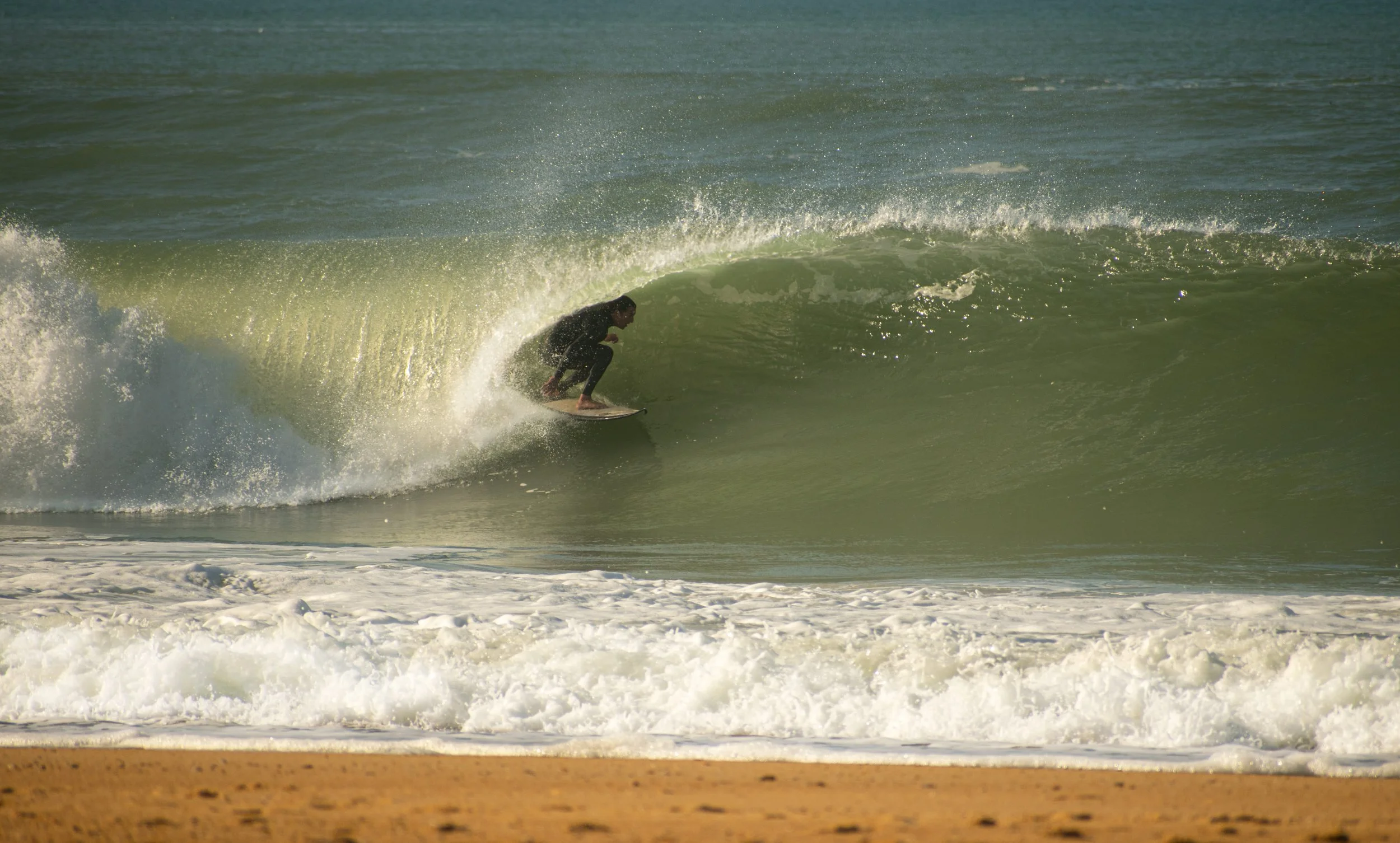 Surfeur avec sa combinaison réparée par TEARING WAVES