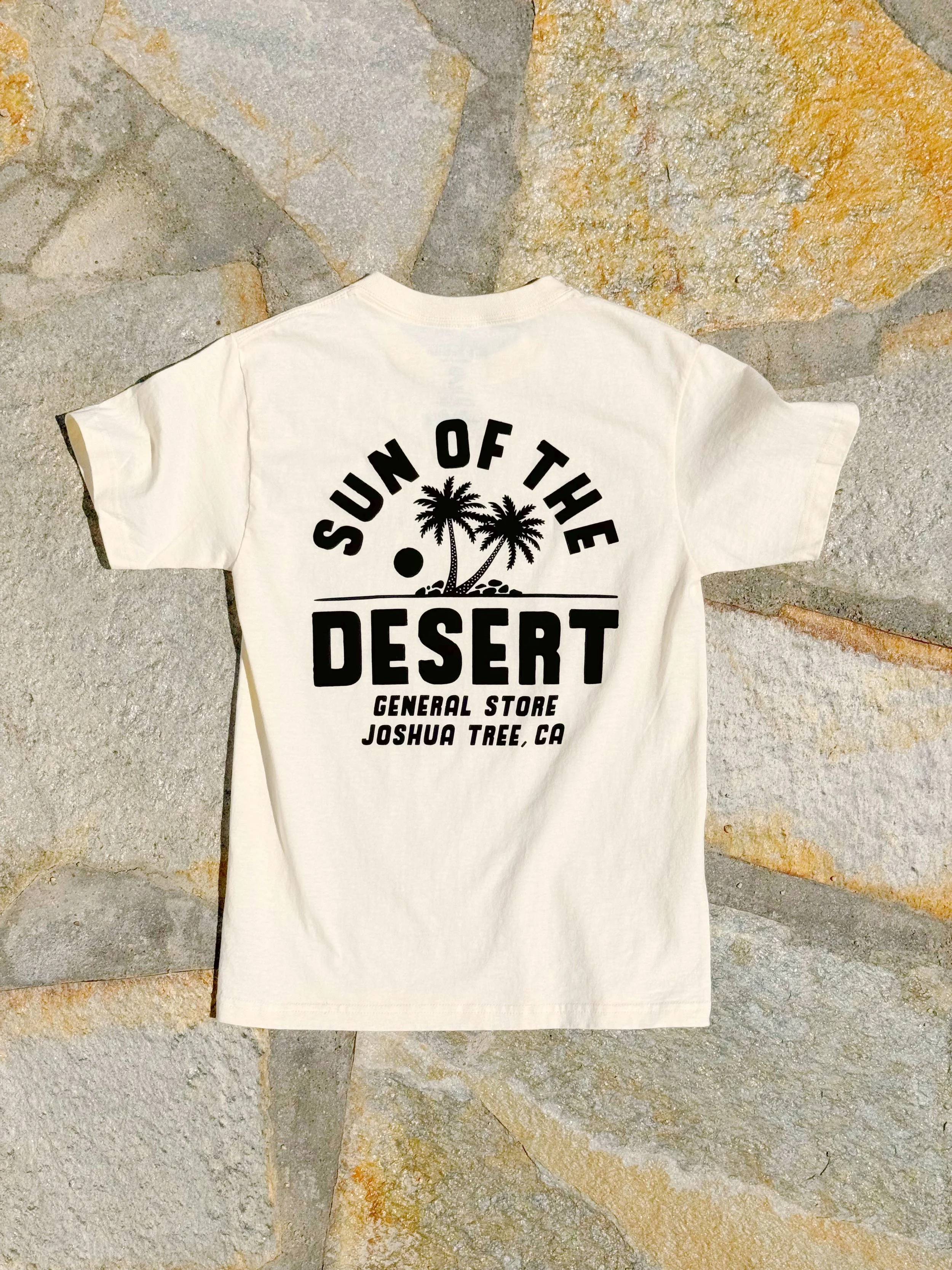 A cream color t shirt with a roadrunner design on the chest