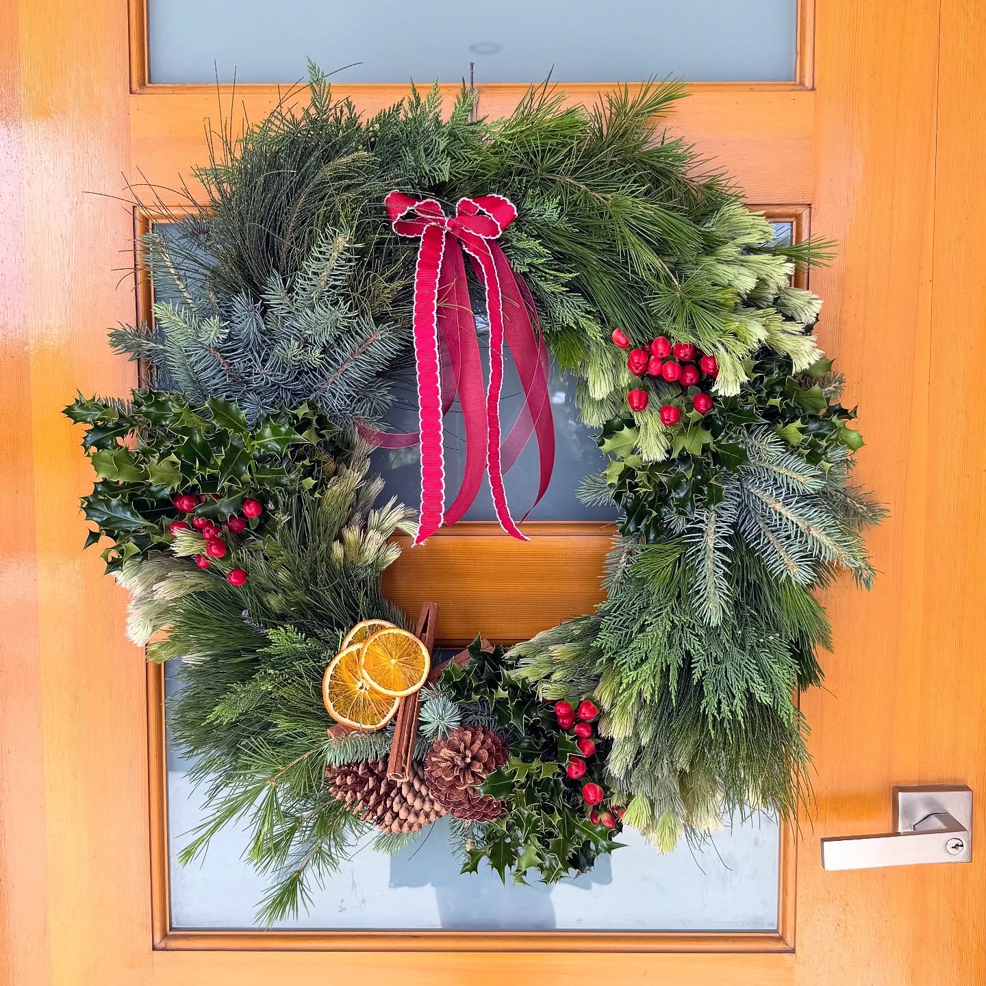 One of our Nordic inspired wreaths sitting pretty in its new home 🦌✨

Featuring holly, cypress, wooly bush, pine, spruce, dried oranges, cinnamon sticks and pine cones 🌲

It&rsquo;s not too late to order a custom wreath for your home. Head to our w