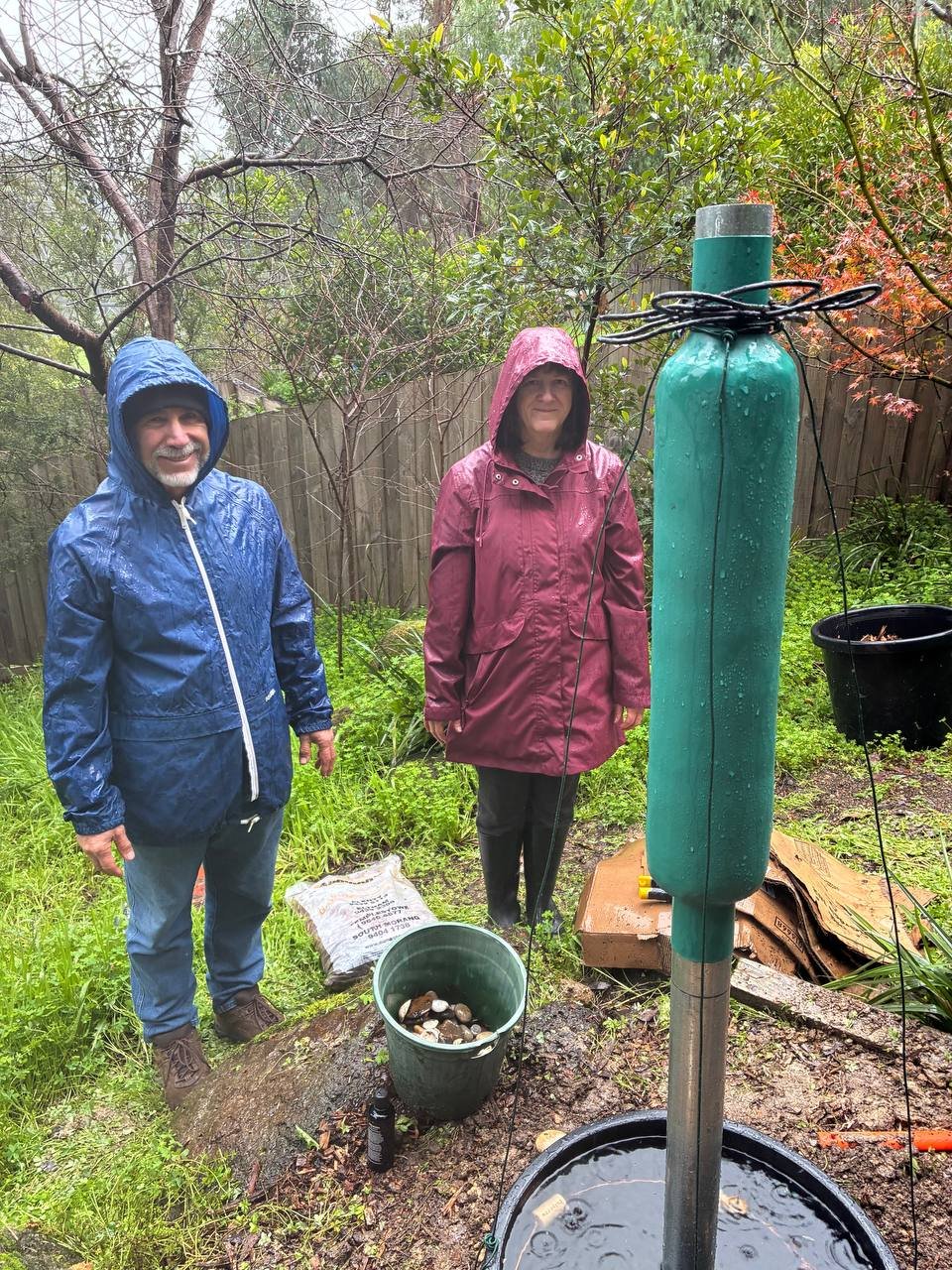 Two people activating a harmony station in Melbourne. A harmony station is a Orgone generator the helps nature and the weather