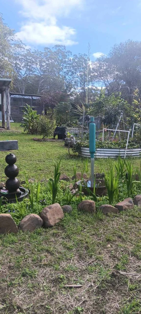A harmony station made into a garden feature. The harmony station helps the garden grow with the increase of rainfall and Orgone energy present.
