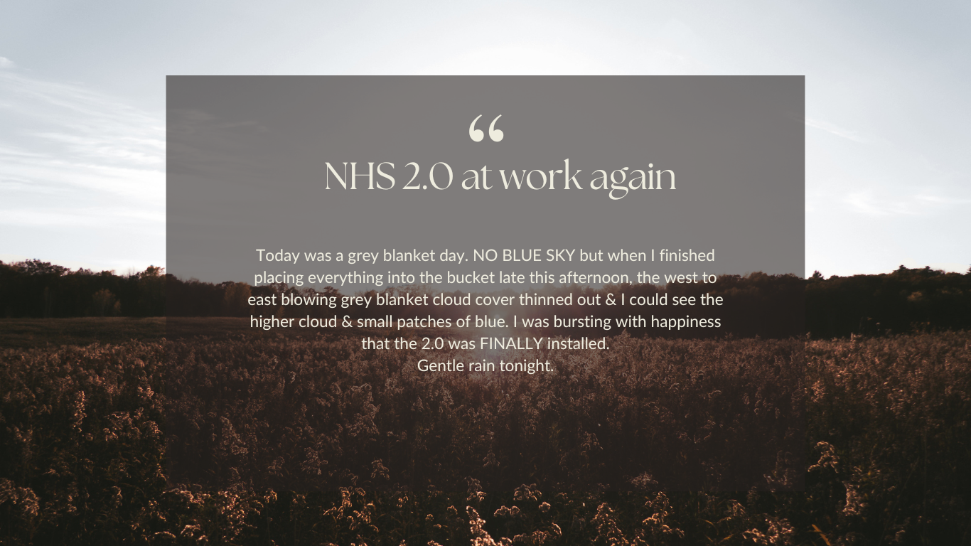A scenic landscape with a grey sky and a field of plants, with a text overlay about experiencing the 2.0 NHS update and enjoying the grey cloud cover.