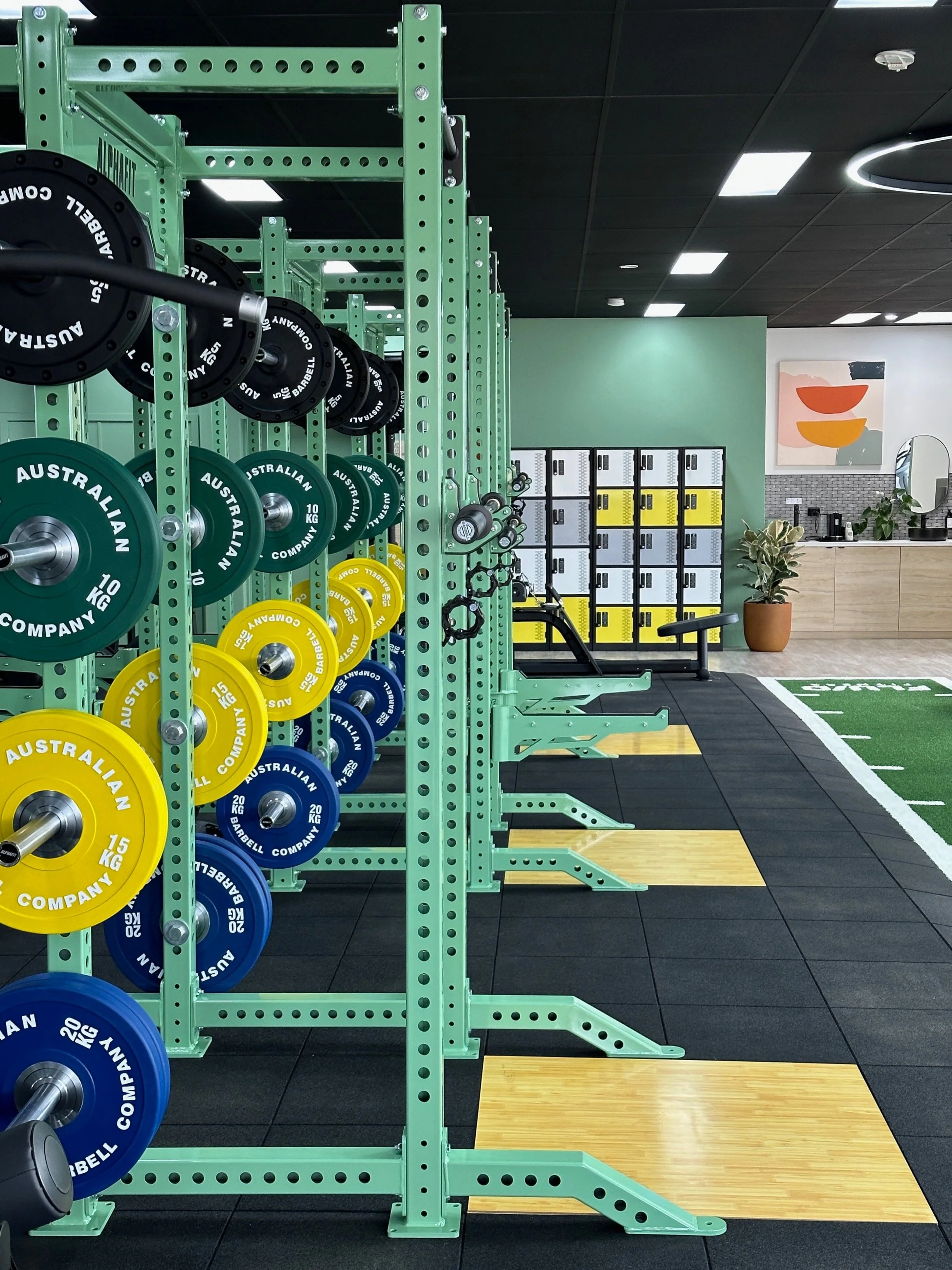 Squat racks with platforms, locker area and kitchenette Fluid Fitness 24/7 gym in Collingwood