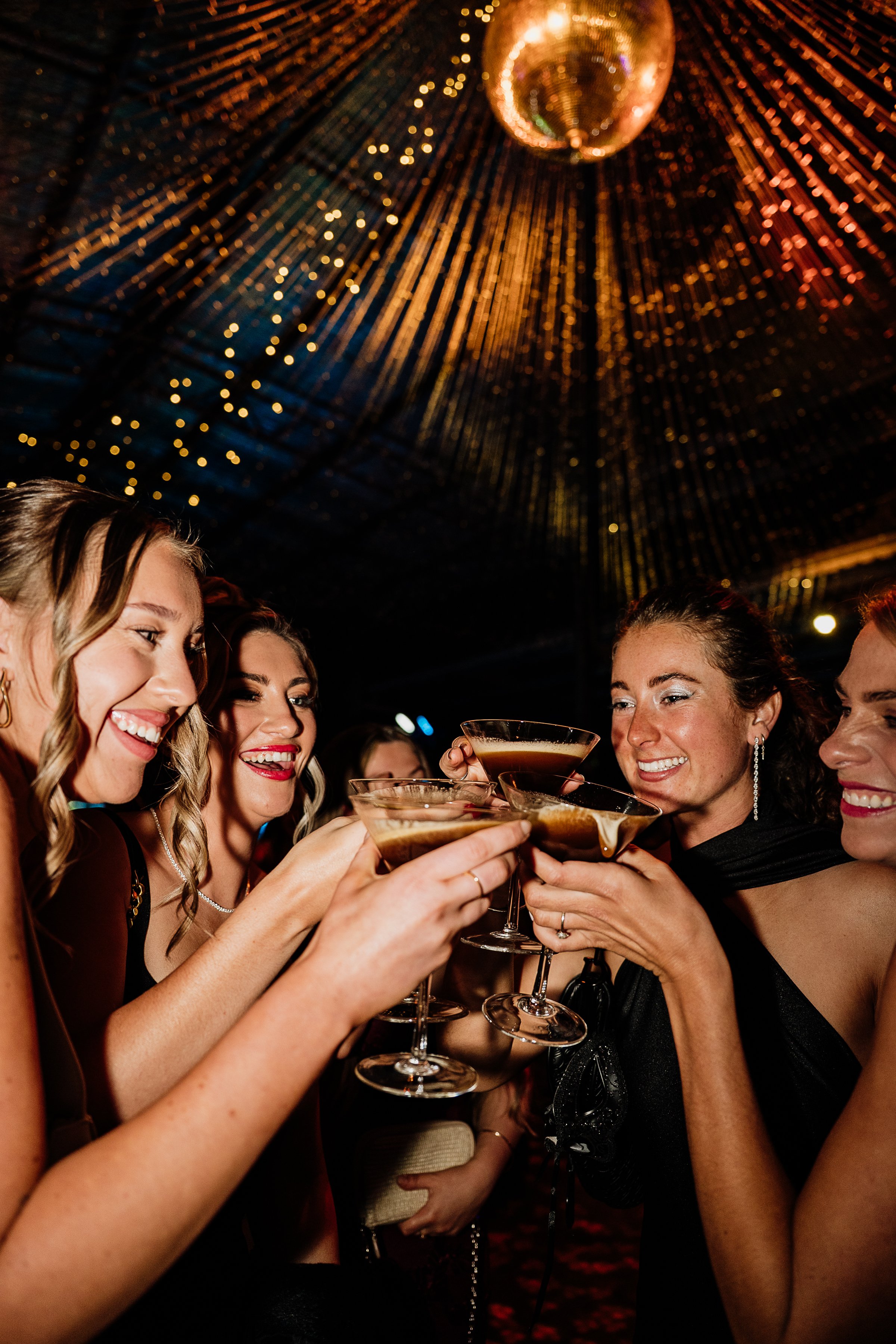 Guests celebrating with champagne during an evening event at Hangar Bar, surrounded by warm ambient lighting in Regional Victoria.