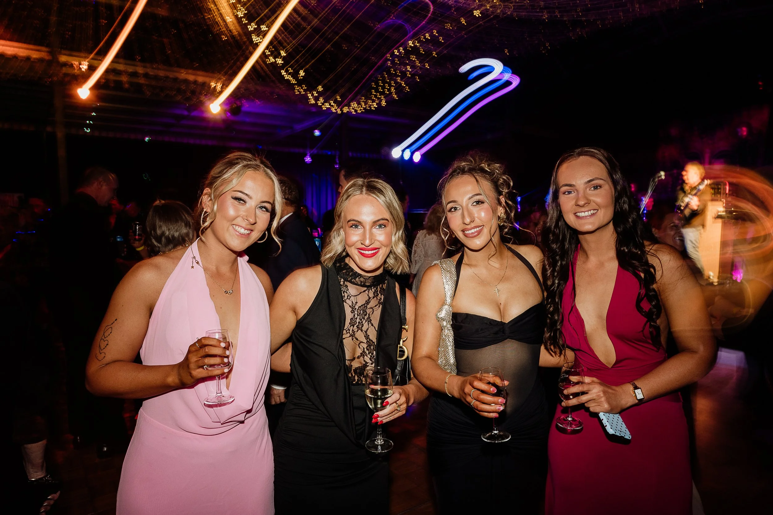 Guests posing for a photo in a local community event at the Hangar Bar
