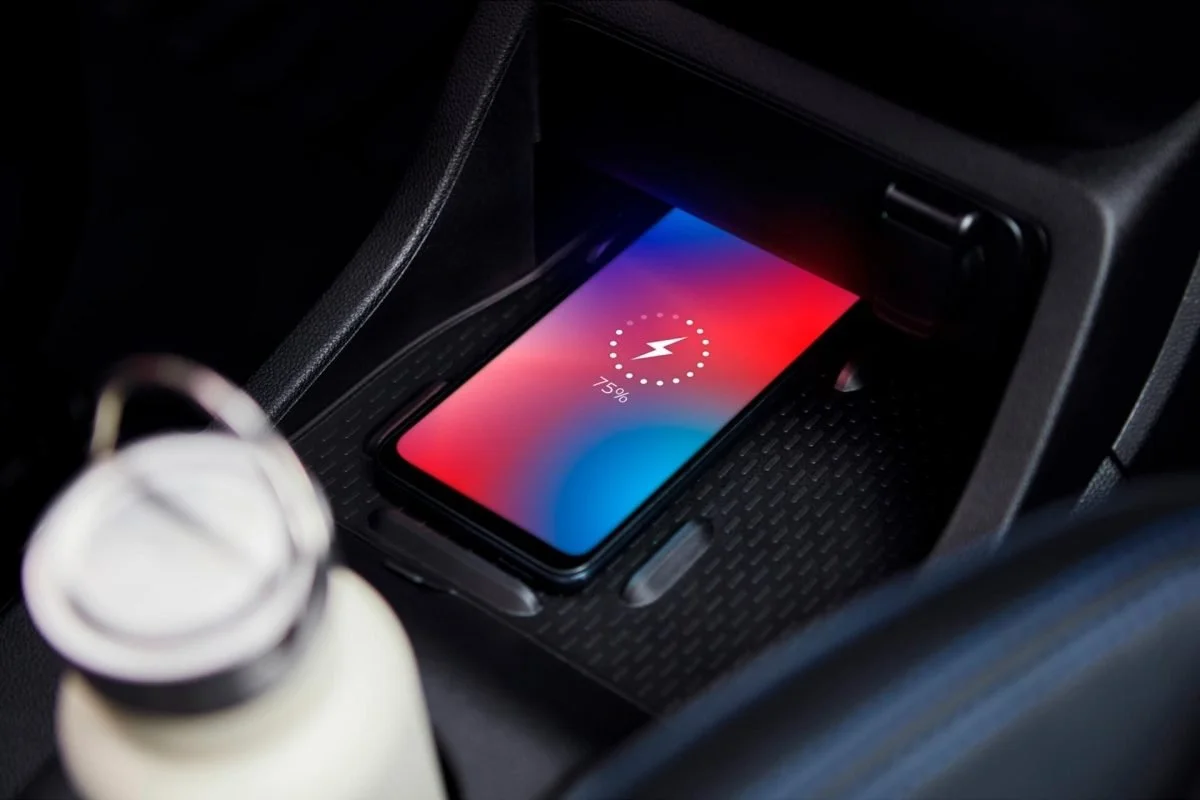 Smartphone in car, in car charger, 75% battery, charging, interior of a vehicle.