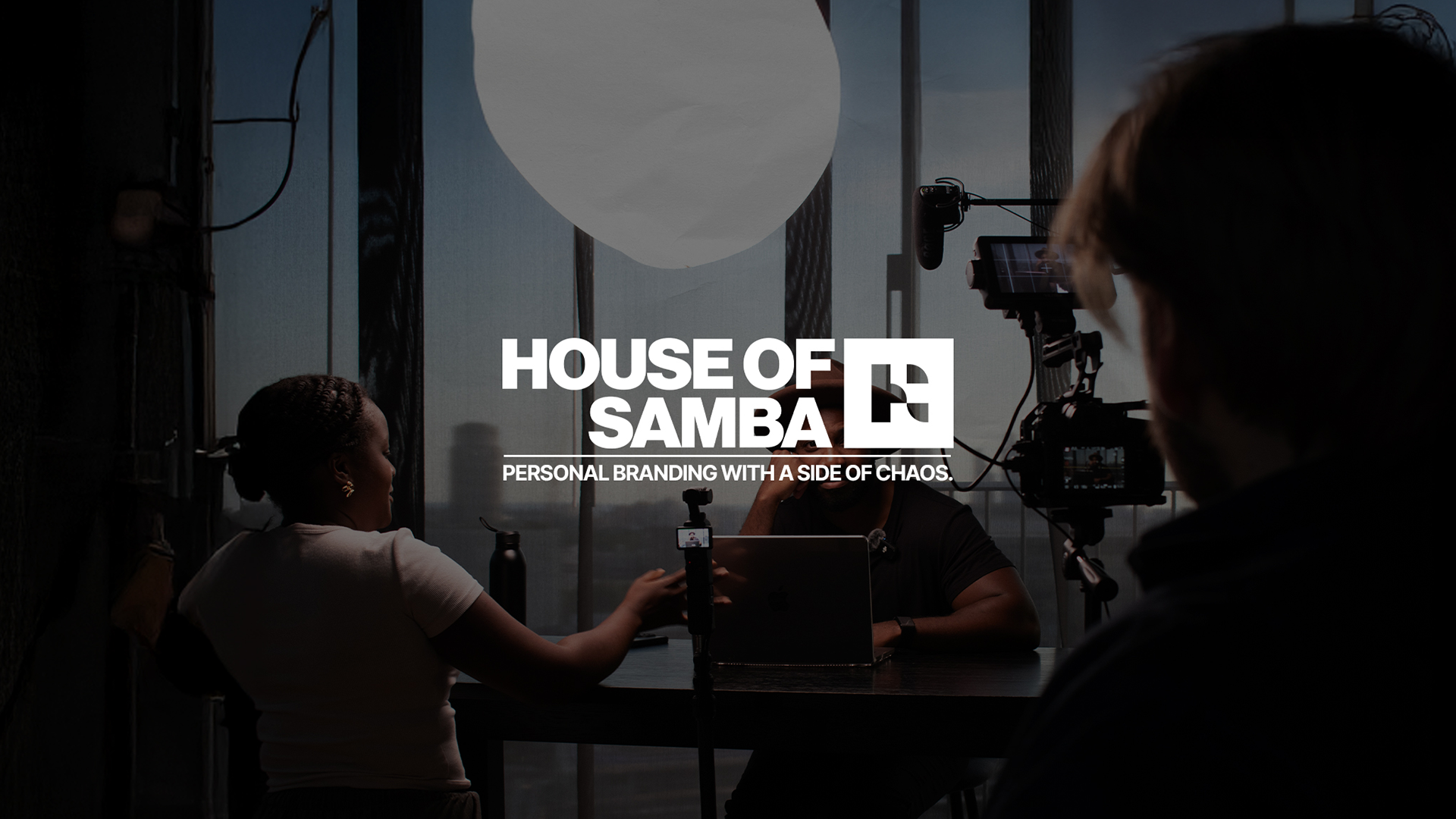 Behind-the-scenes still from a House of Samba video shoot, showing a personal branding setup with camera, lighting, and crew in a studio environment, featuring the House of Samba logo and tagline on screen.