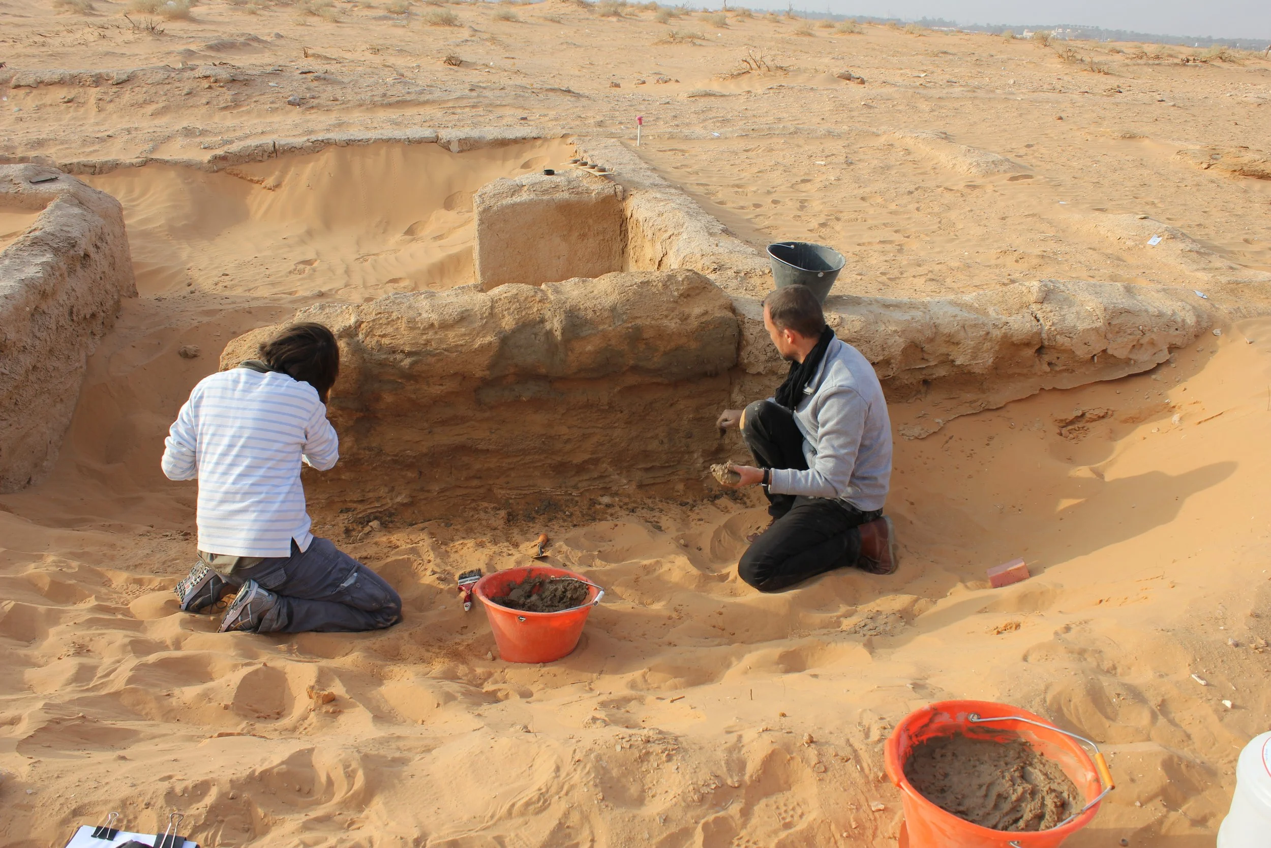 Traditional mudbrick wall restoration using straw, camel dung, and clay render, Saudi Arabia