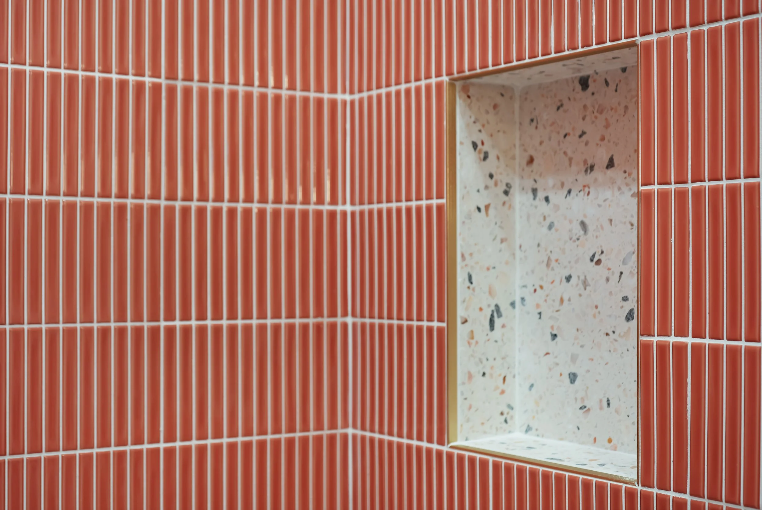 Coral tile with terrazzo niche
