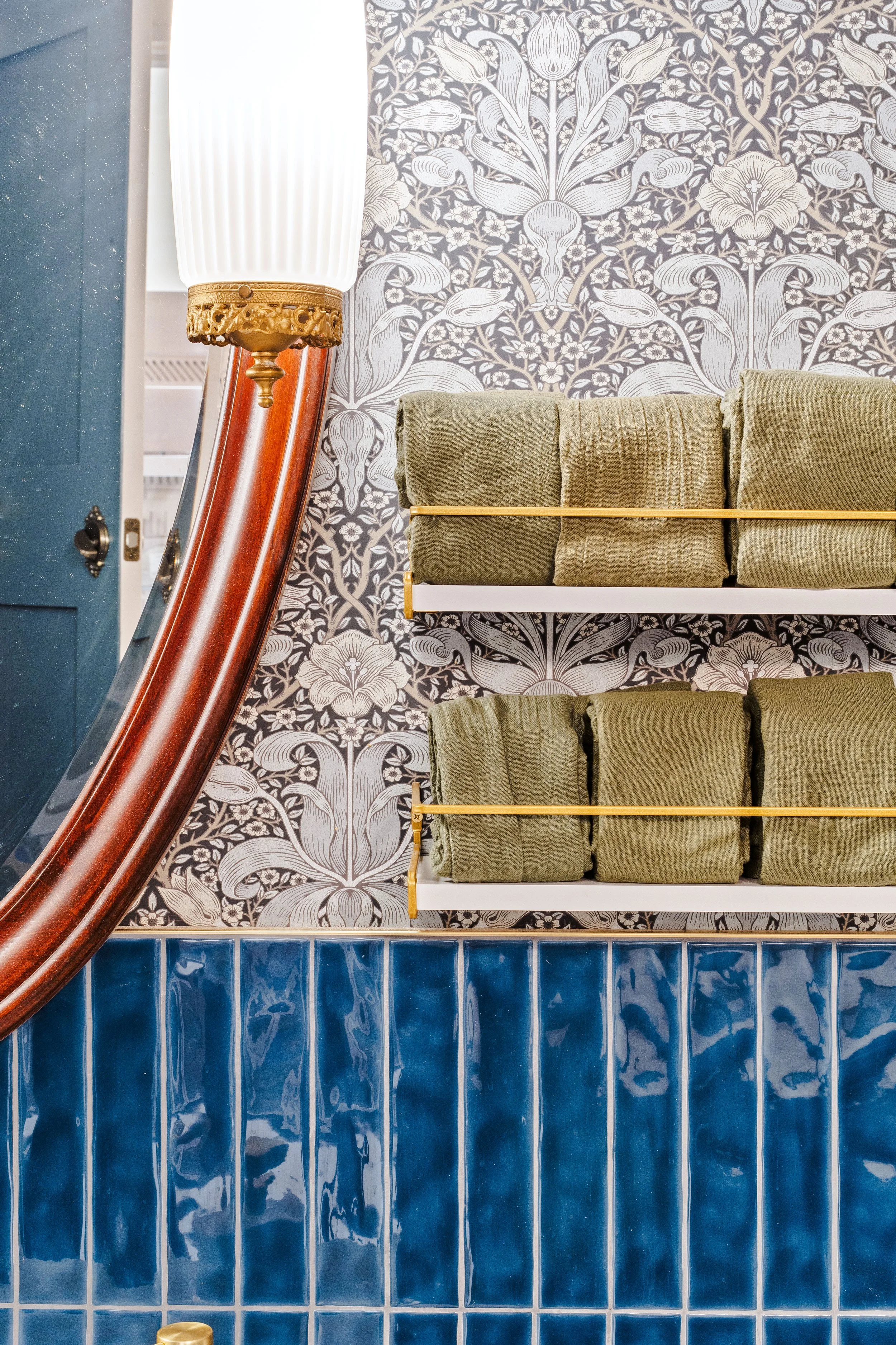 Detail shot of bathroom shelves, mirror and vanity light.