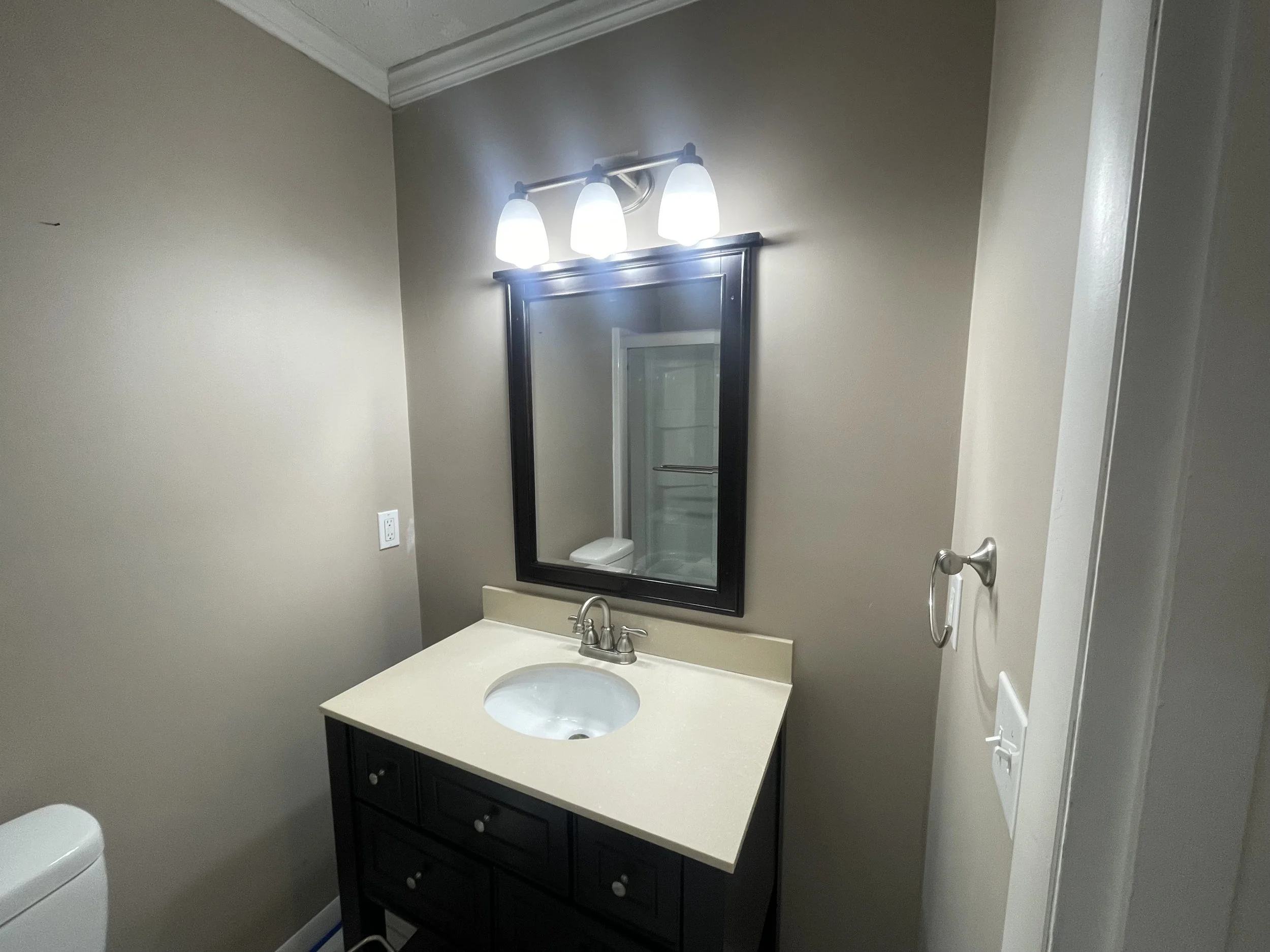 Dated bathroom vanity before renovation