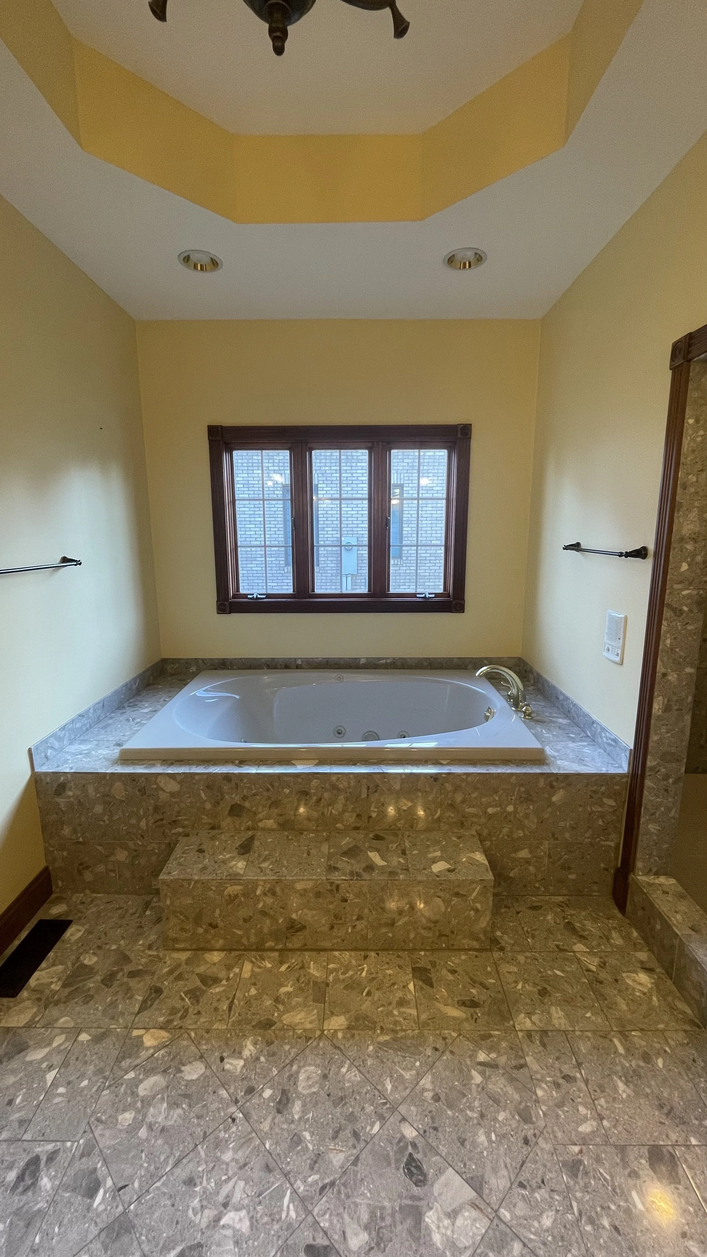 Drop in tub and coffered ceilings in master bathroom