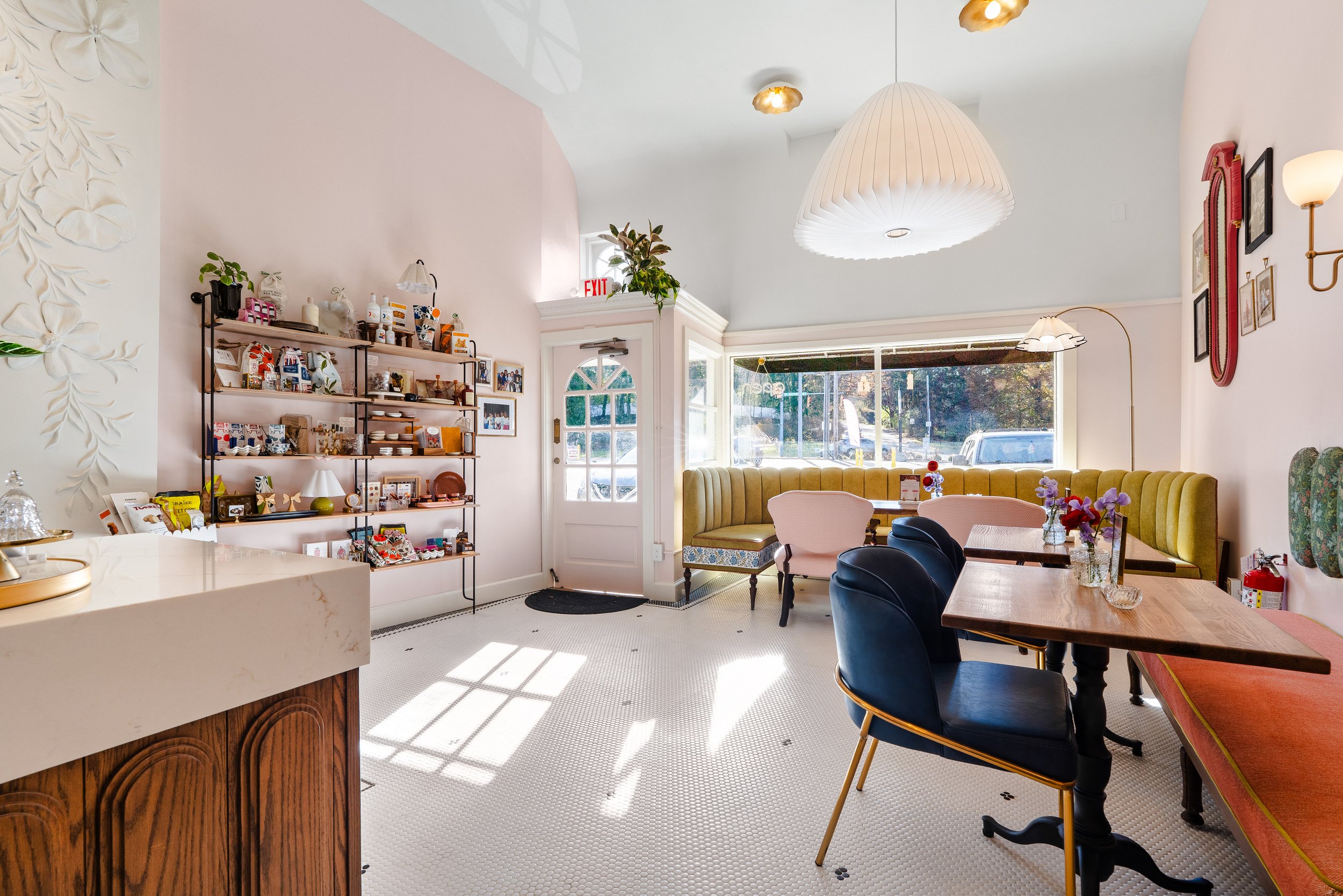 View to the front of the cafe where there is seating with built in upholstered benches.