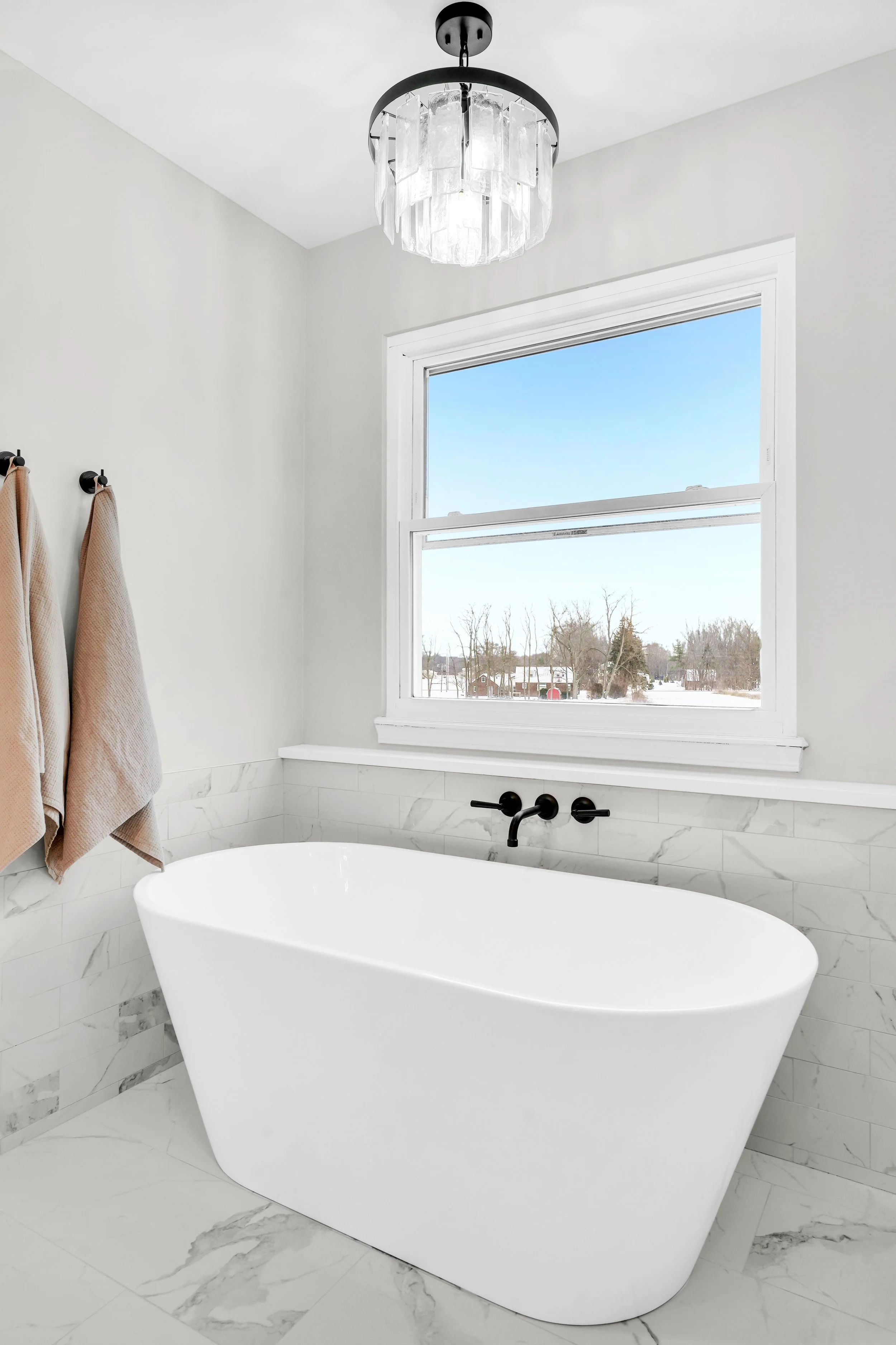 Modern freestanding tub with wall mounted tub filer