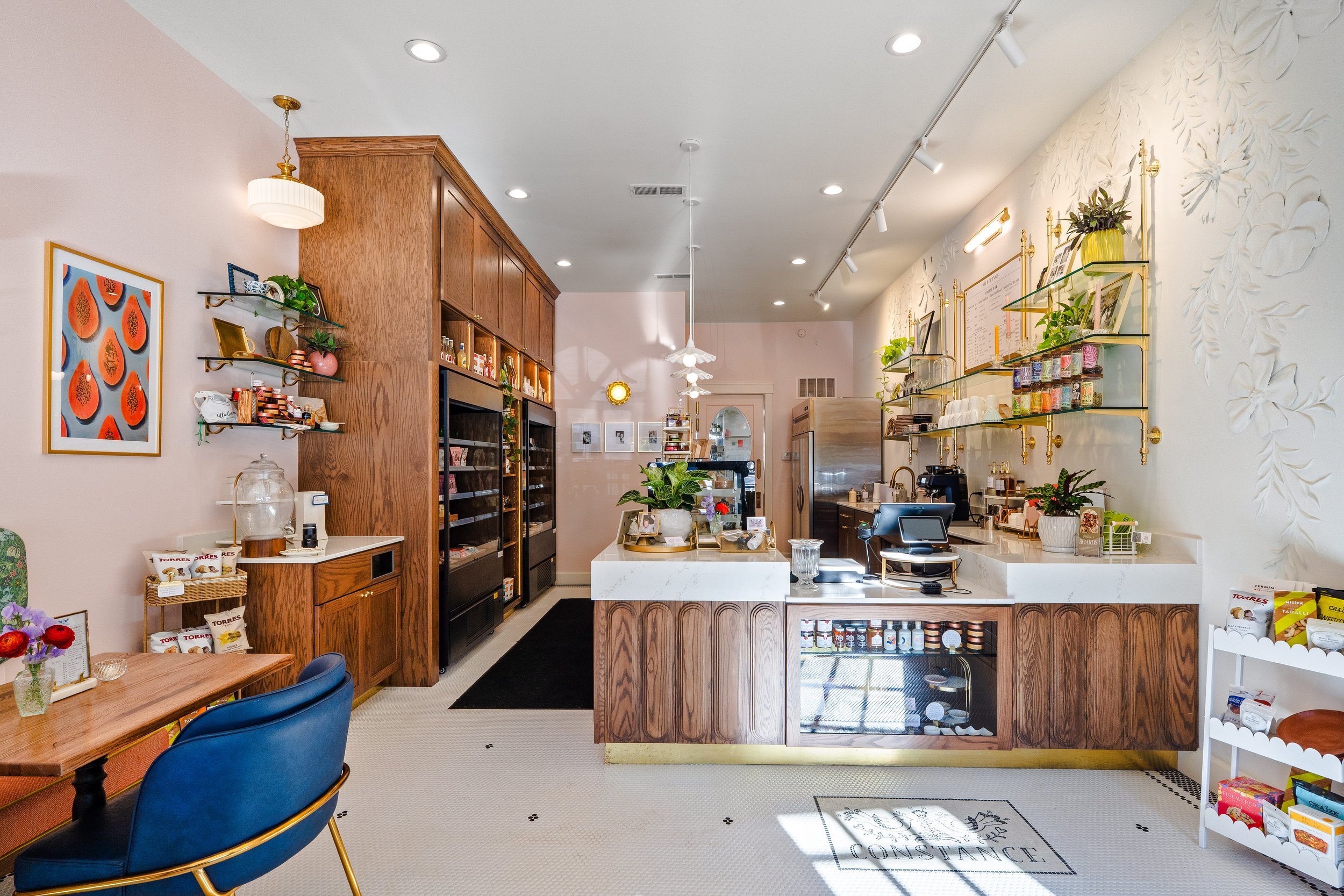 Post renovation photo of Constance Fromagerie and Cafe looking towards counter and register.