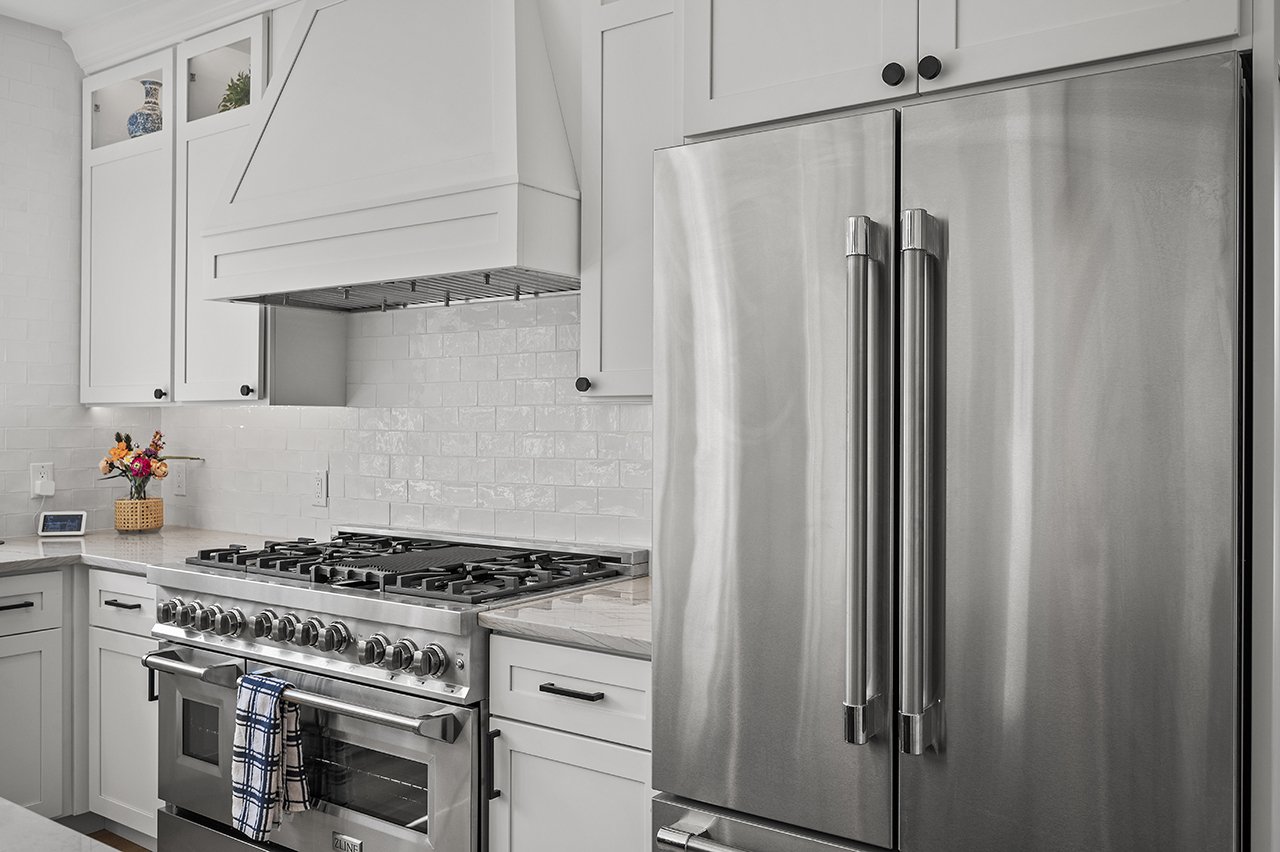 A matching eight burner stove and a French door refrigerator in the newly renovated kitchen.