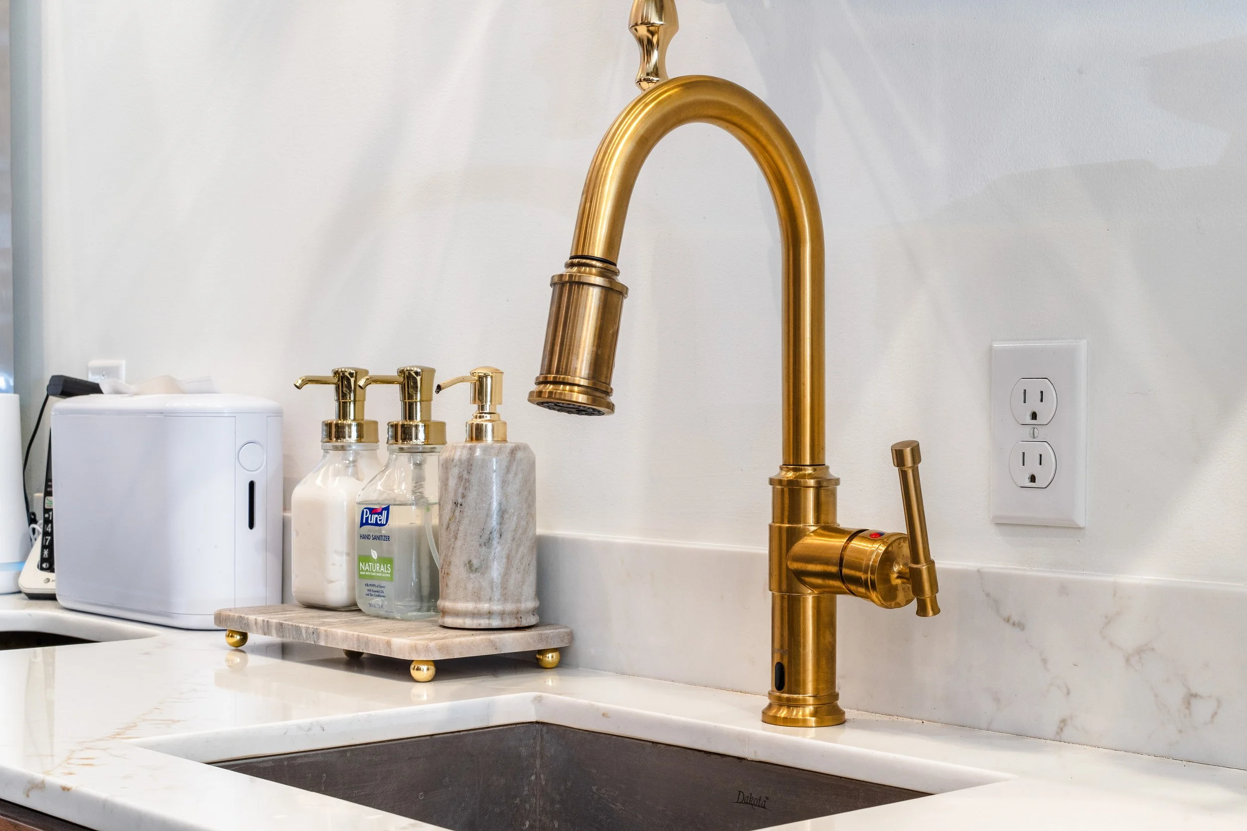 Gold faucet behind the bar area.