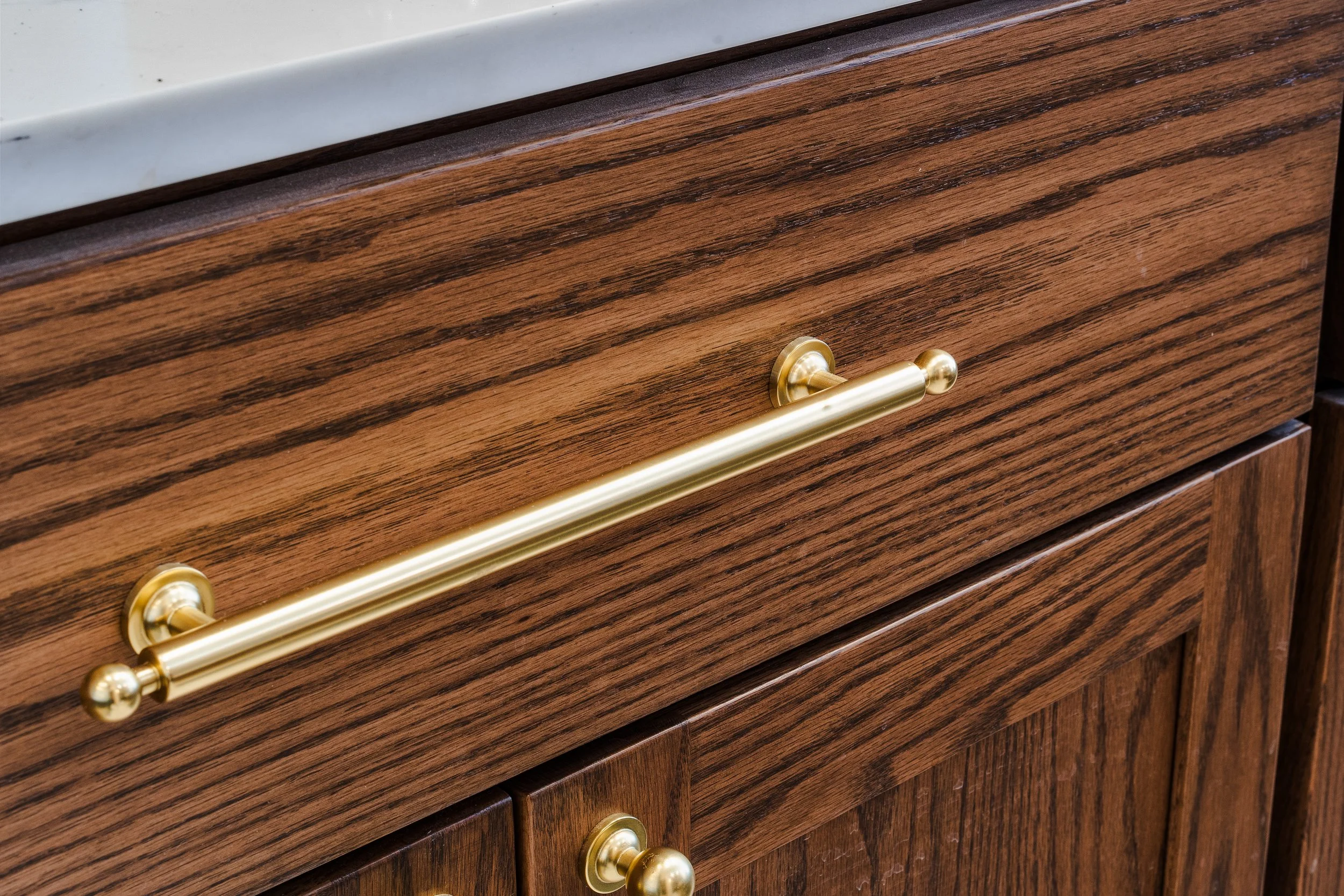 Custom cabinetry and brass cabinet pulls.