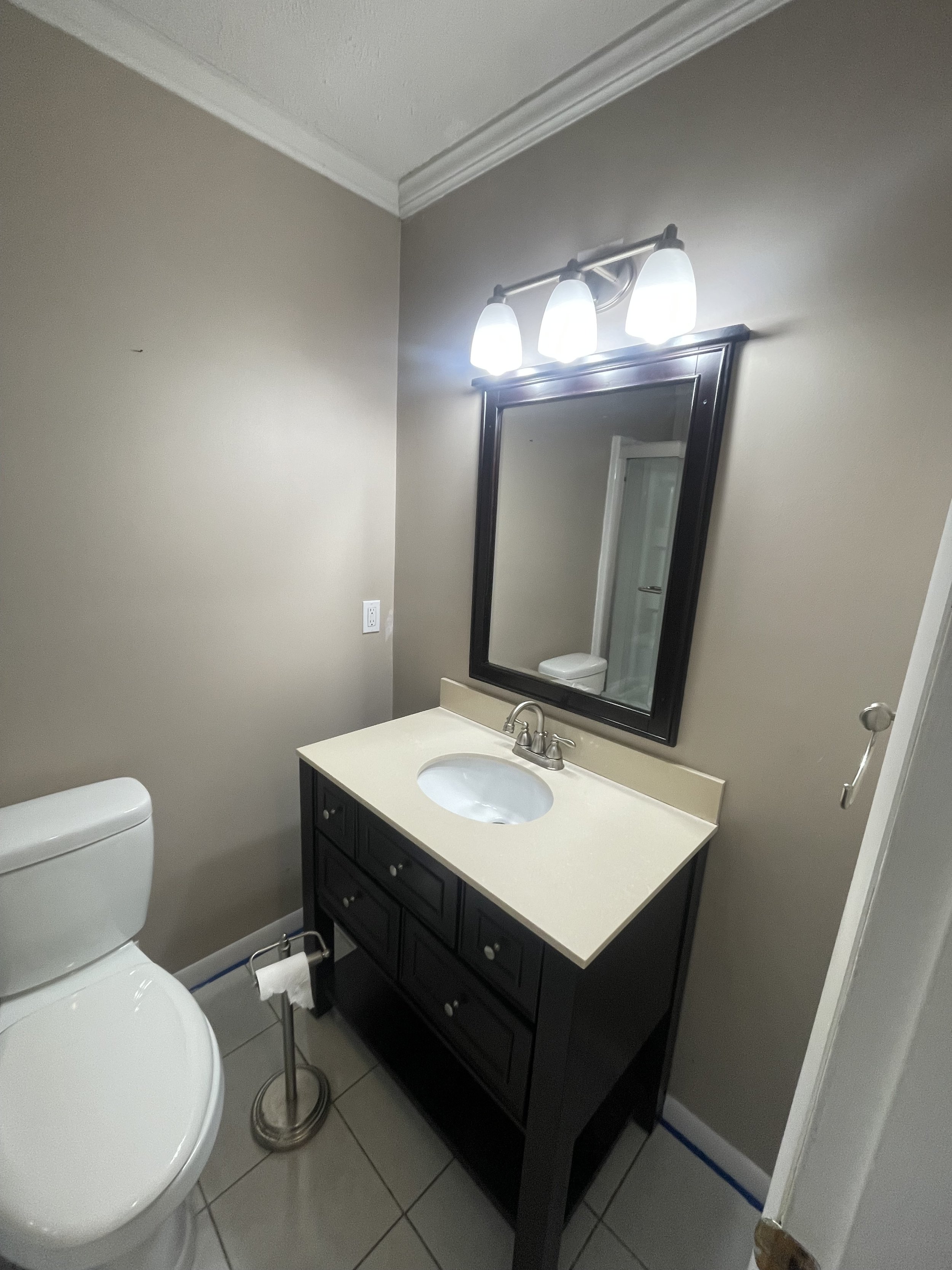 Dated bathroom vanity before renovation