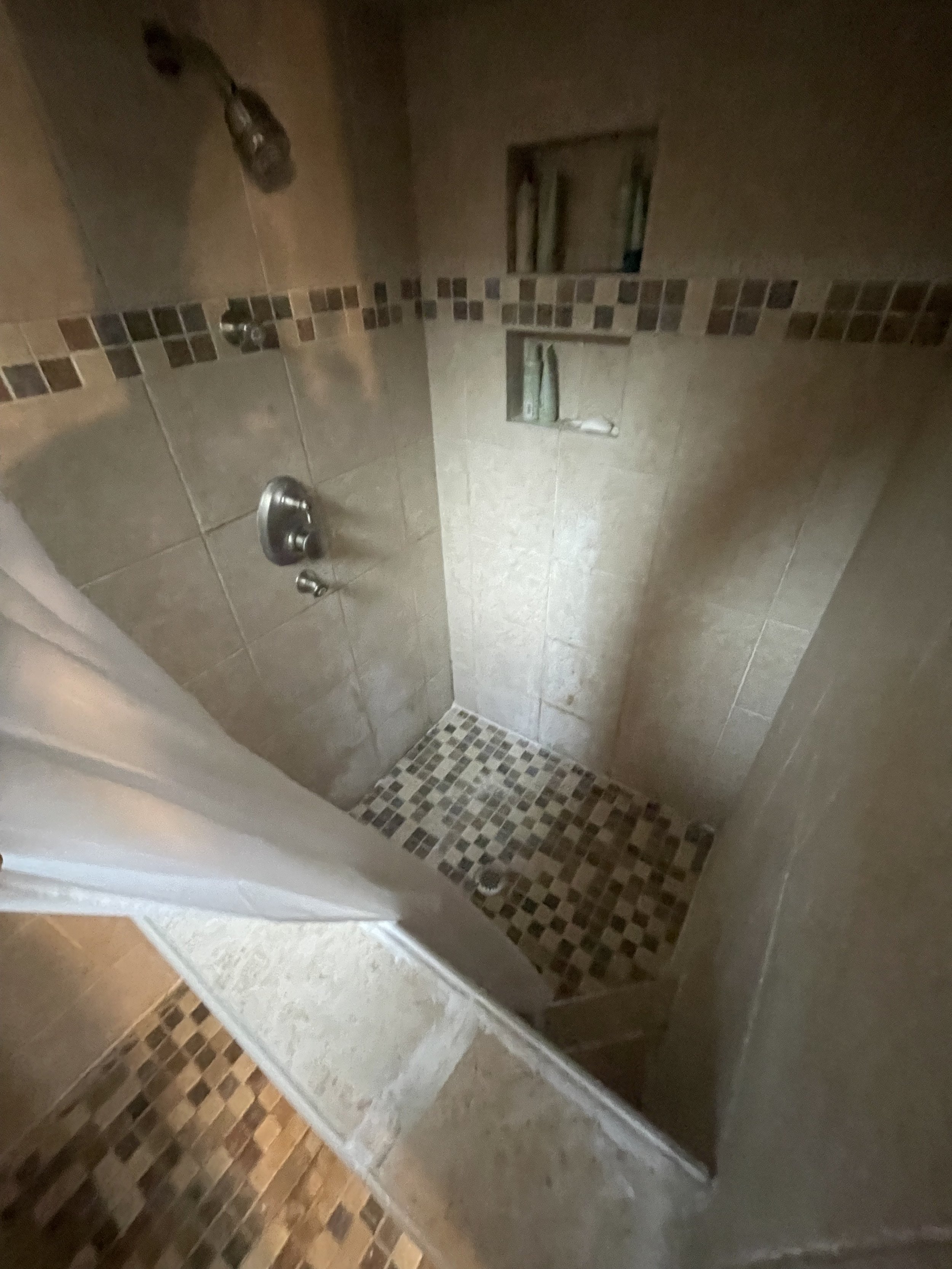 Beige shower with niches and mosaic floor