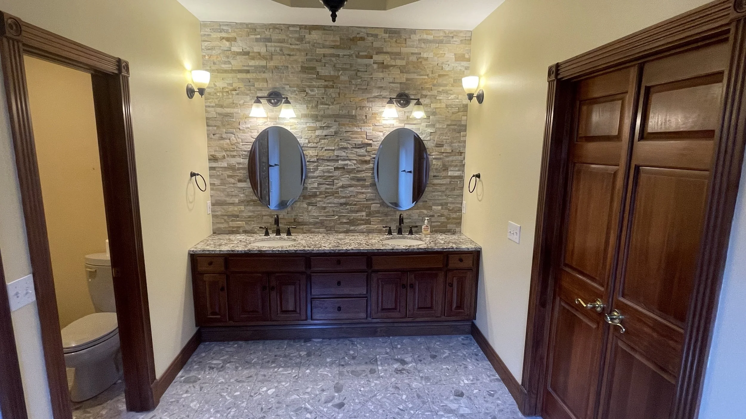 Before photo of bathroom looking from tub towards vanity.