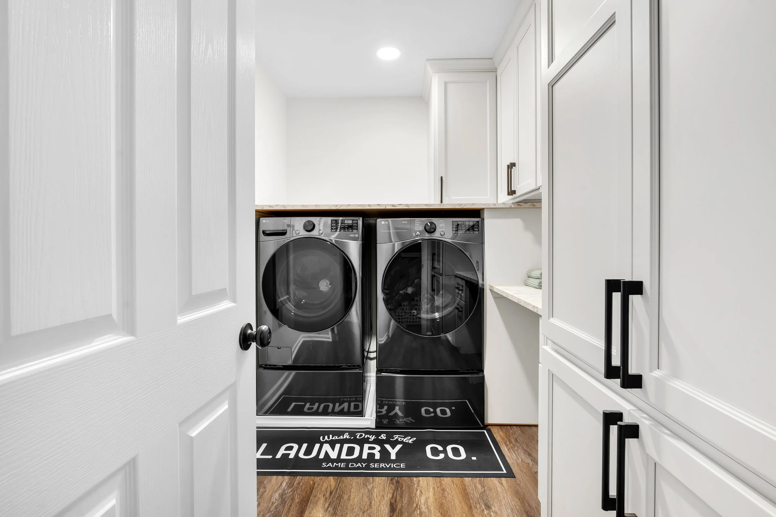 Renovated laundry room with built in cabinetry