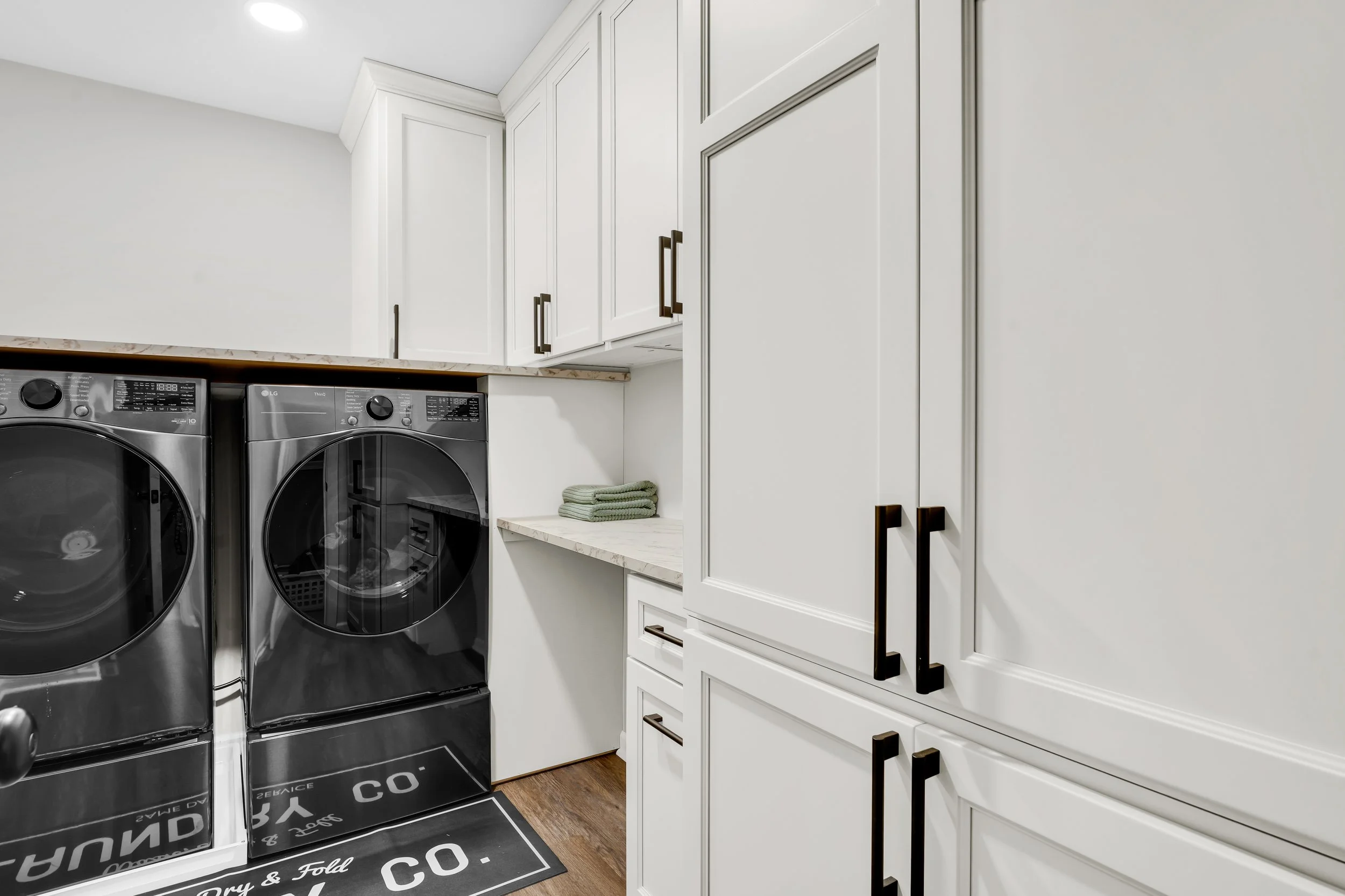 Renovated laundry room with built in cabinetry