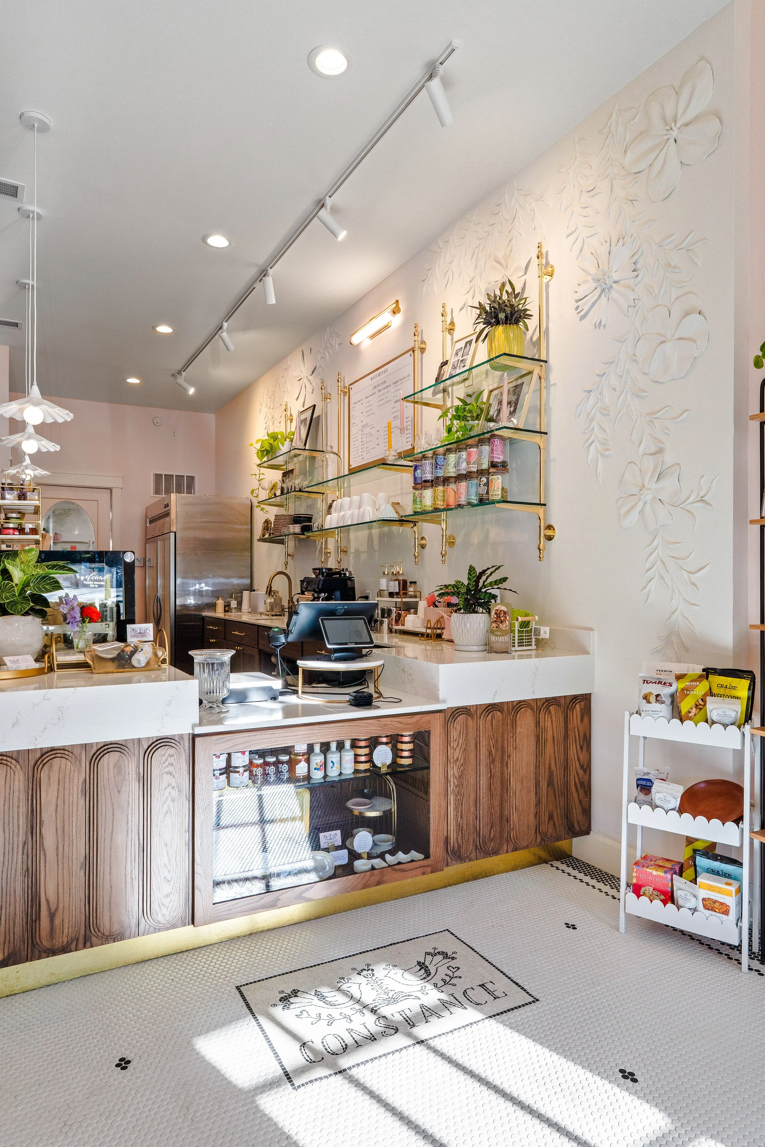 Post renovation photo of Constance Fromagerie and Cafe looking towards counter and register.