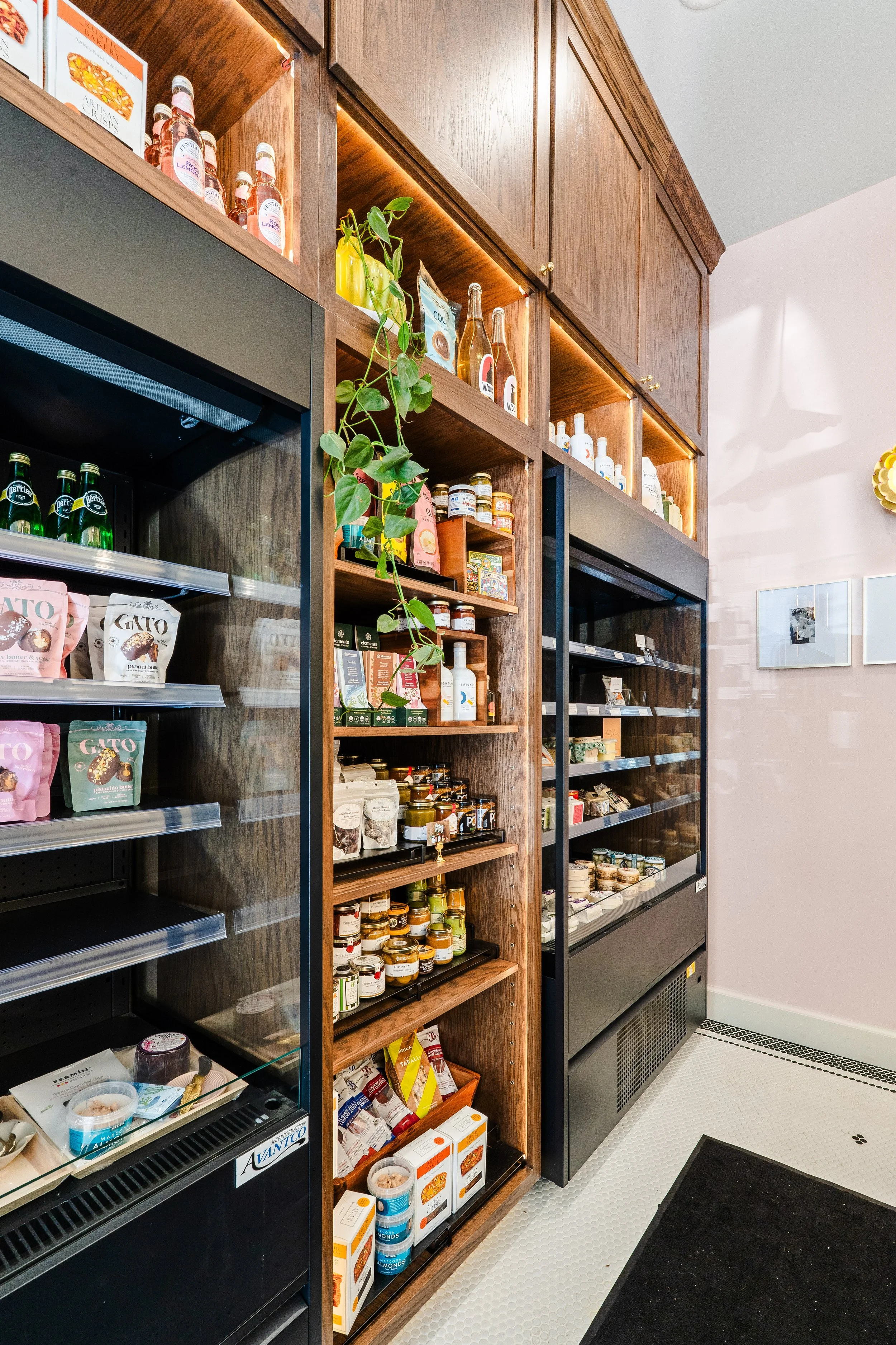 To-go refrigerated area along aisle in front of Constance's charcuterie assembly bar.