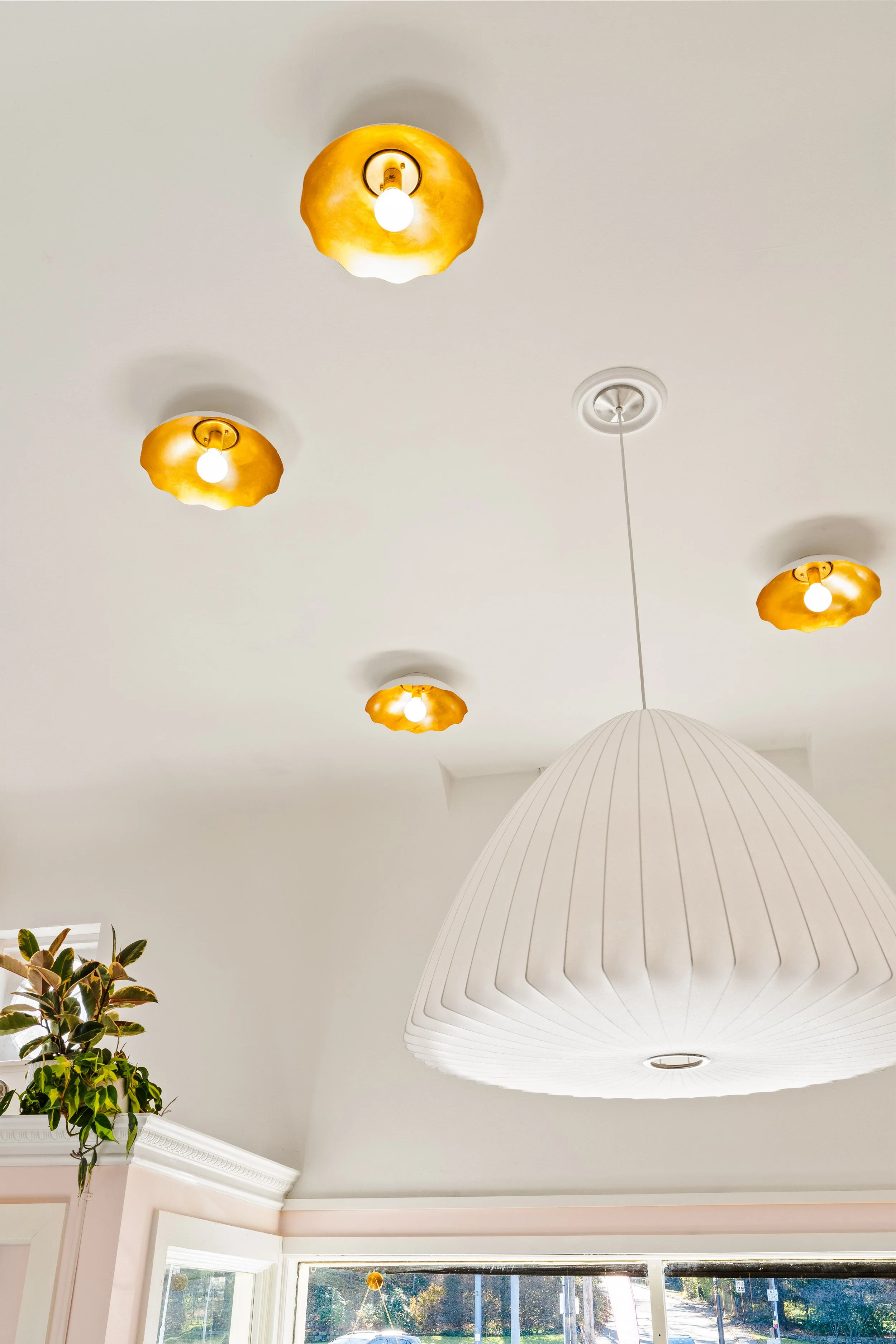 Ceiling lights and large pendant light above the eating area.