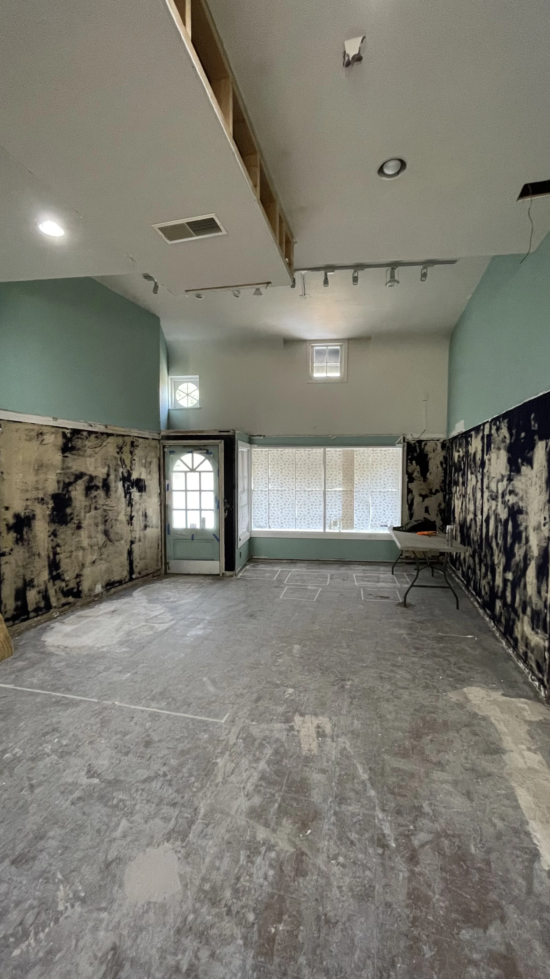 Mid construction of an empty retail storefront before renovation.