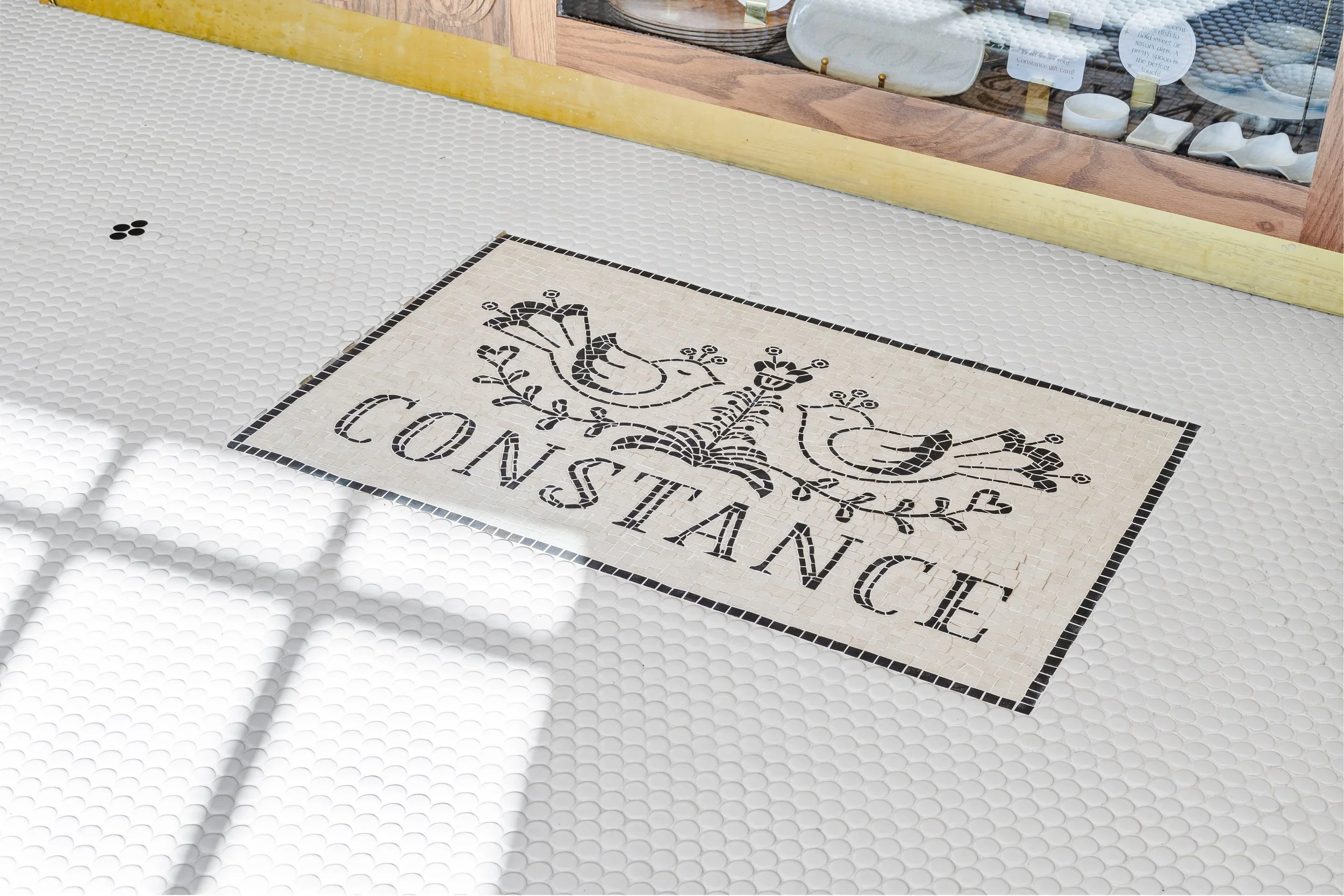 Floor mosaic with Constance's logo in it.