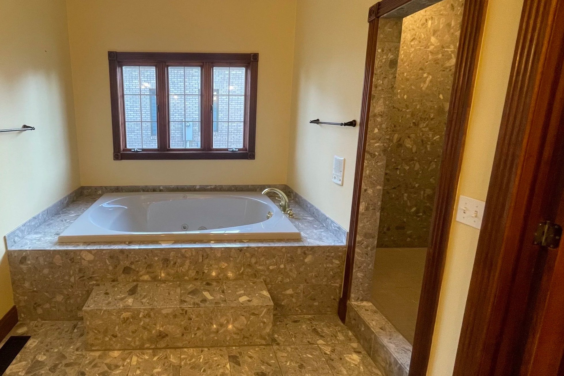 Drop in tub and the entrance to a walk in shower in master bathroom.