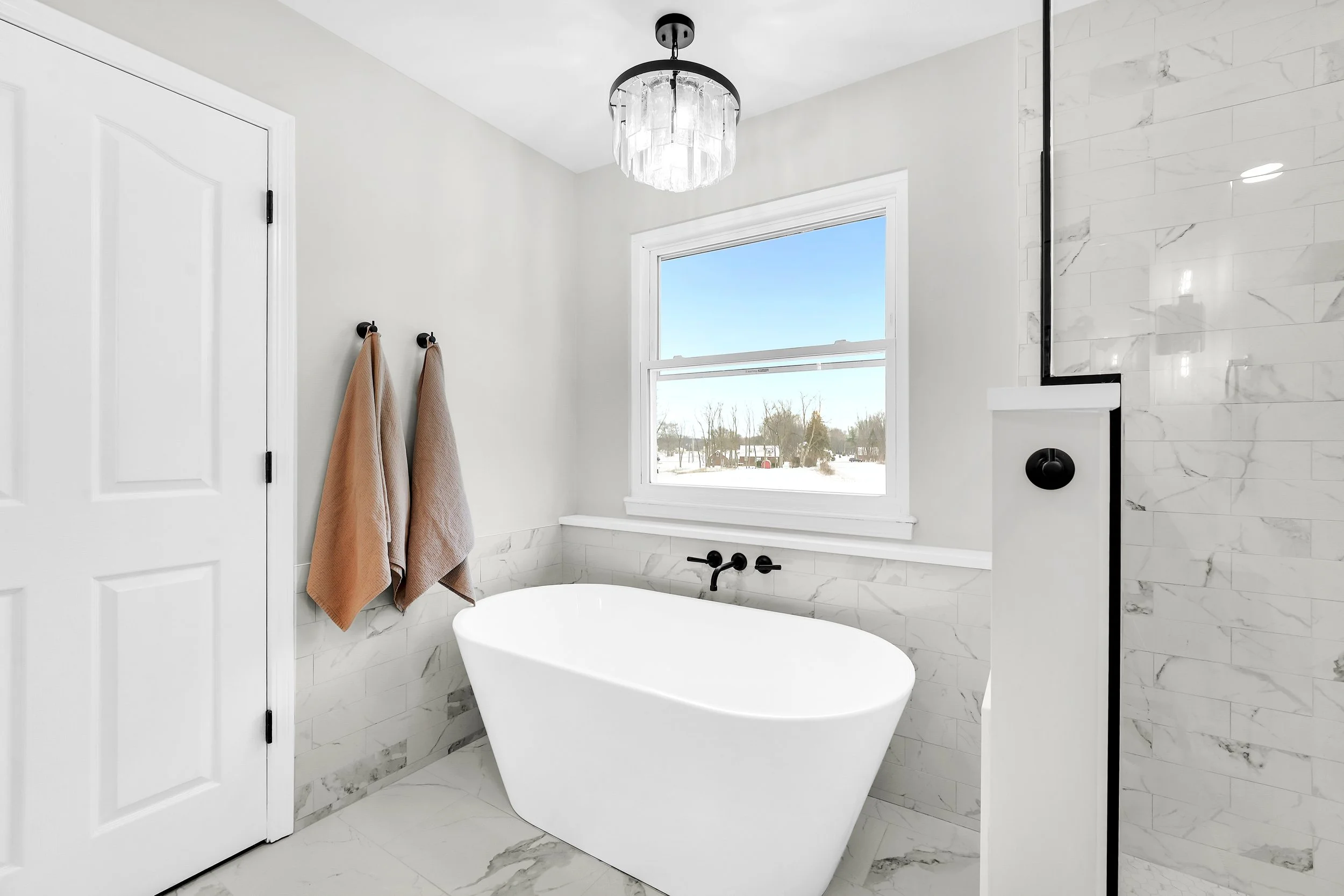 Modern freestanding tub with wall mounted tub filer