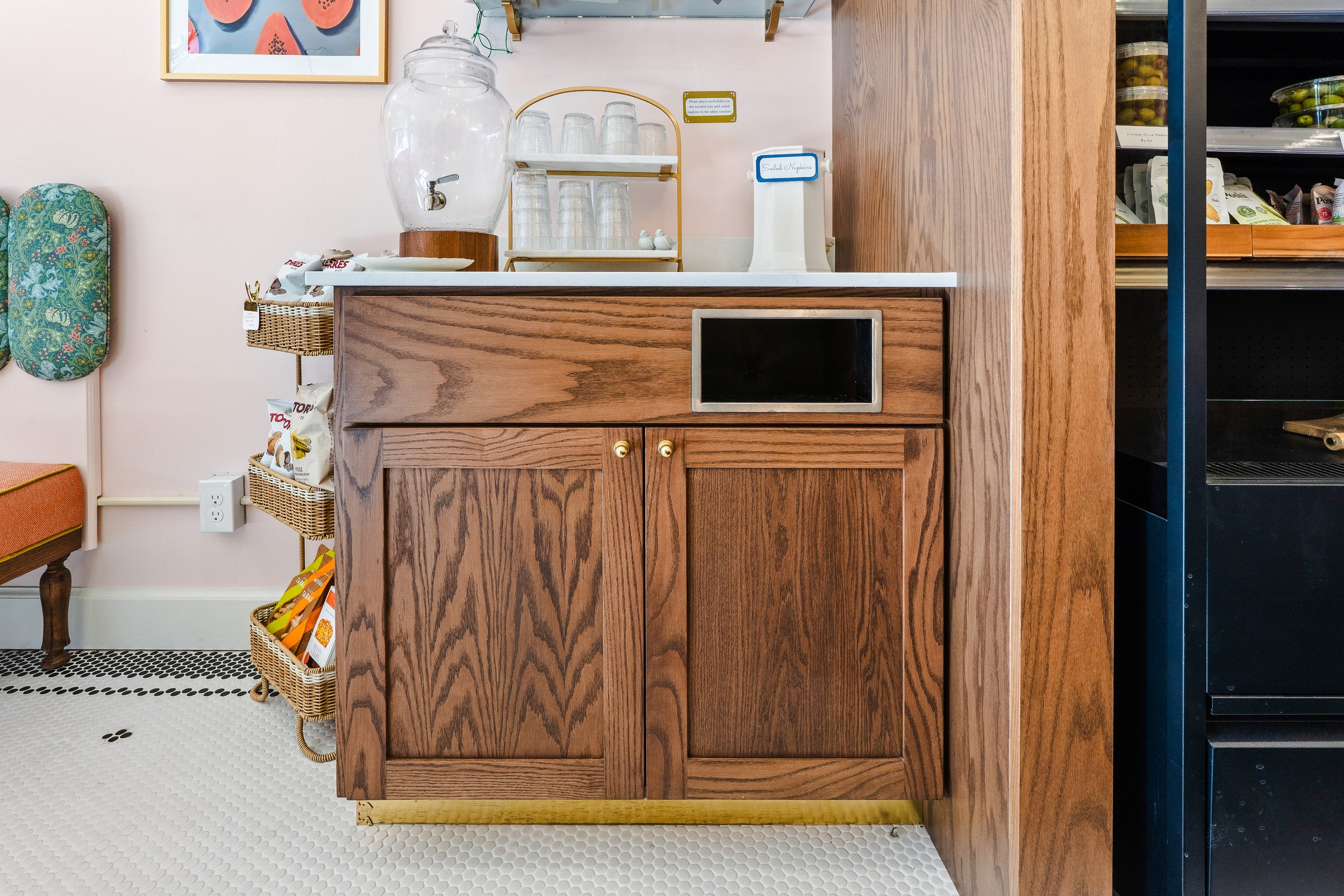 Built-in trash can in front dining are of the cafe.