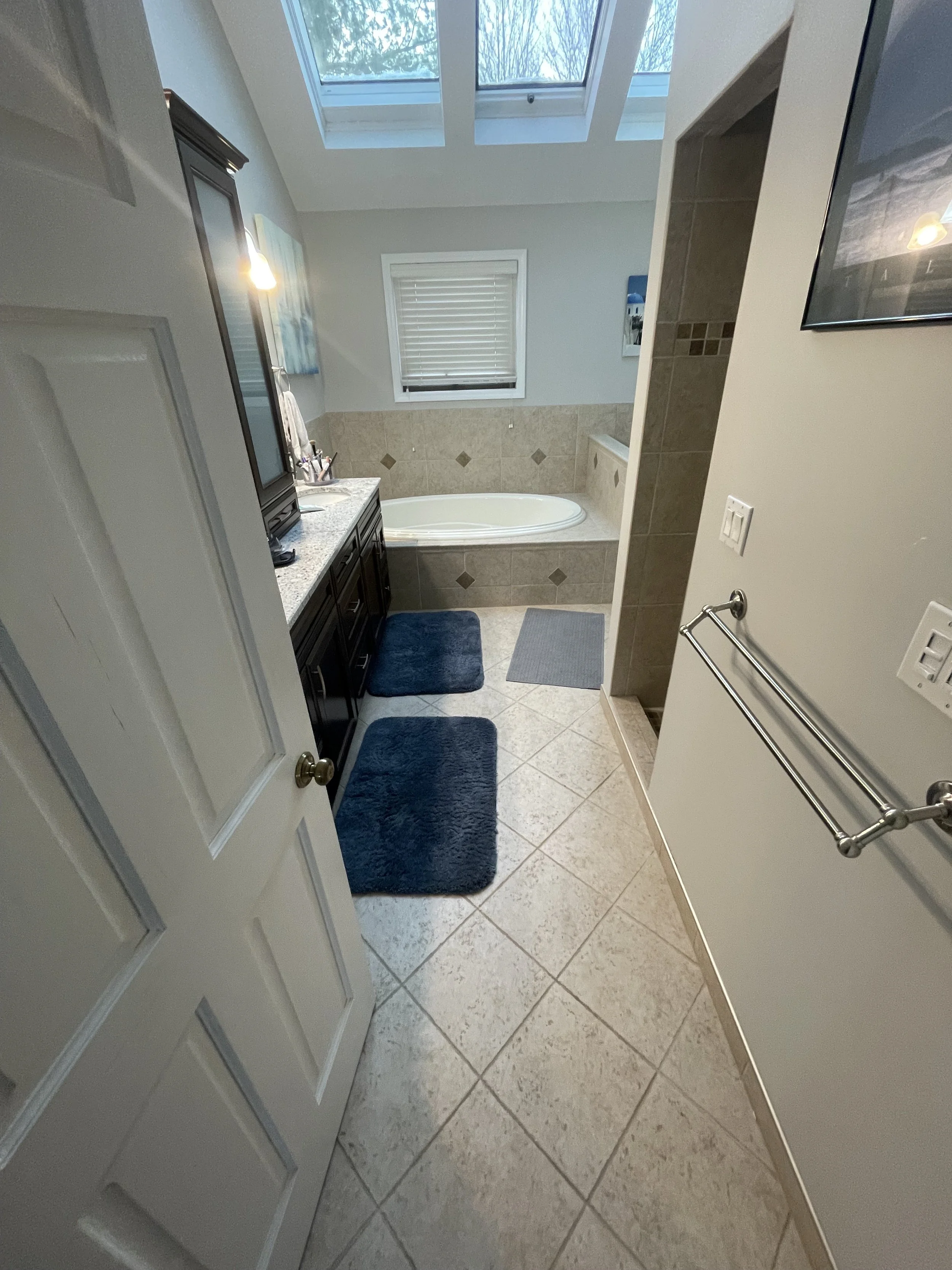 Before photo of bathroom with jacuzzi tub at the back wall of the room
