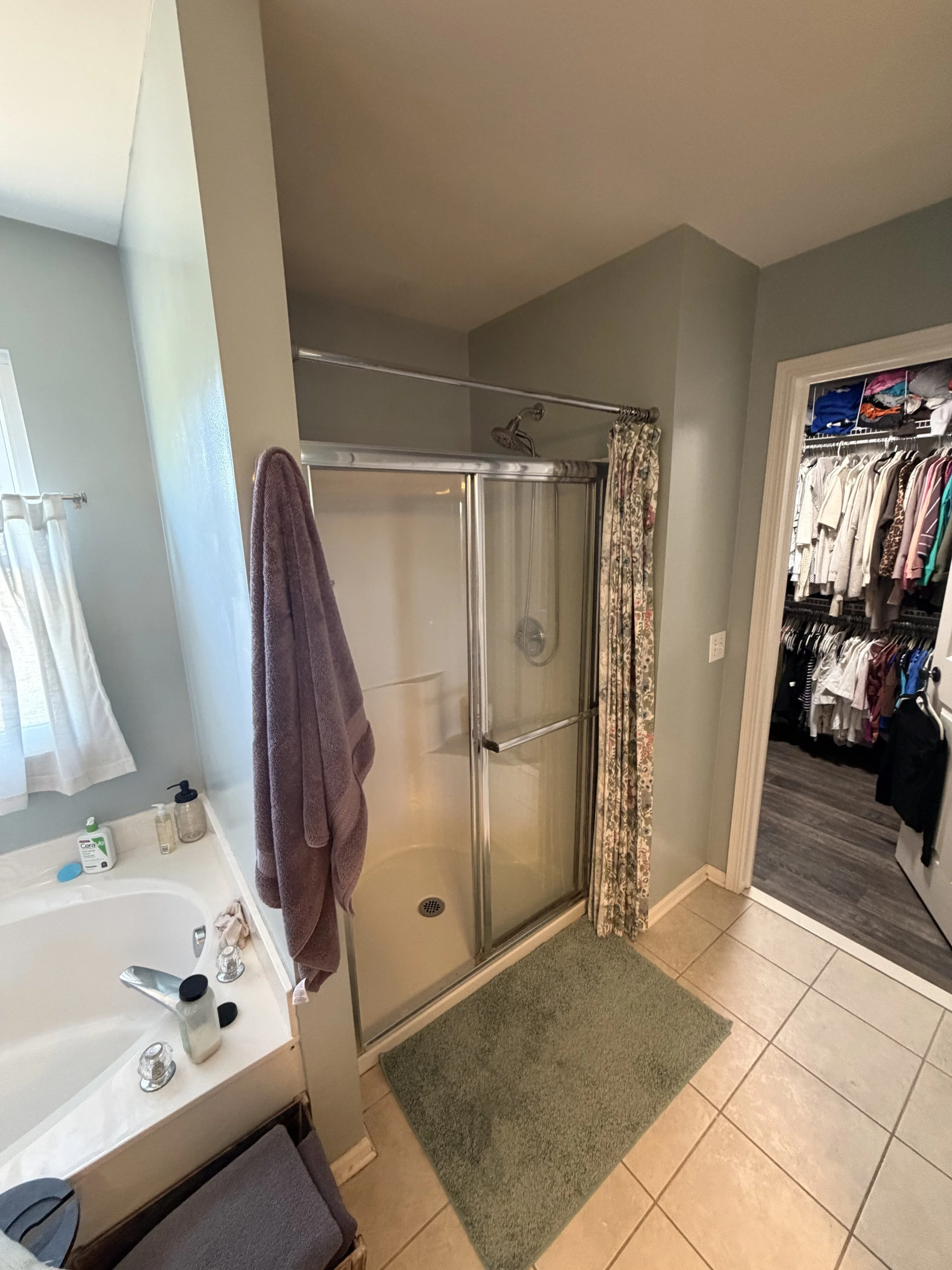 Pre-renovation shower stall with sliding glass door.