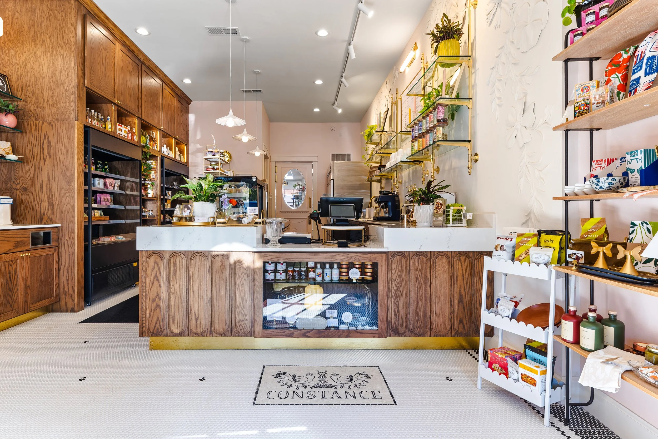 Post renovation photo of Constance Fromagerie and Cafe looking towards counter and displays.