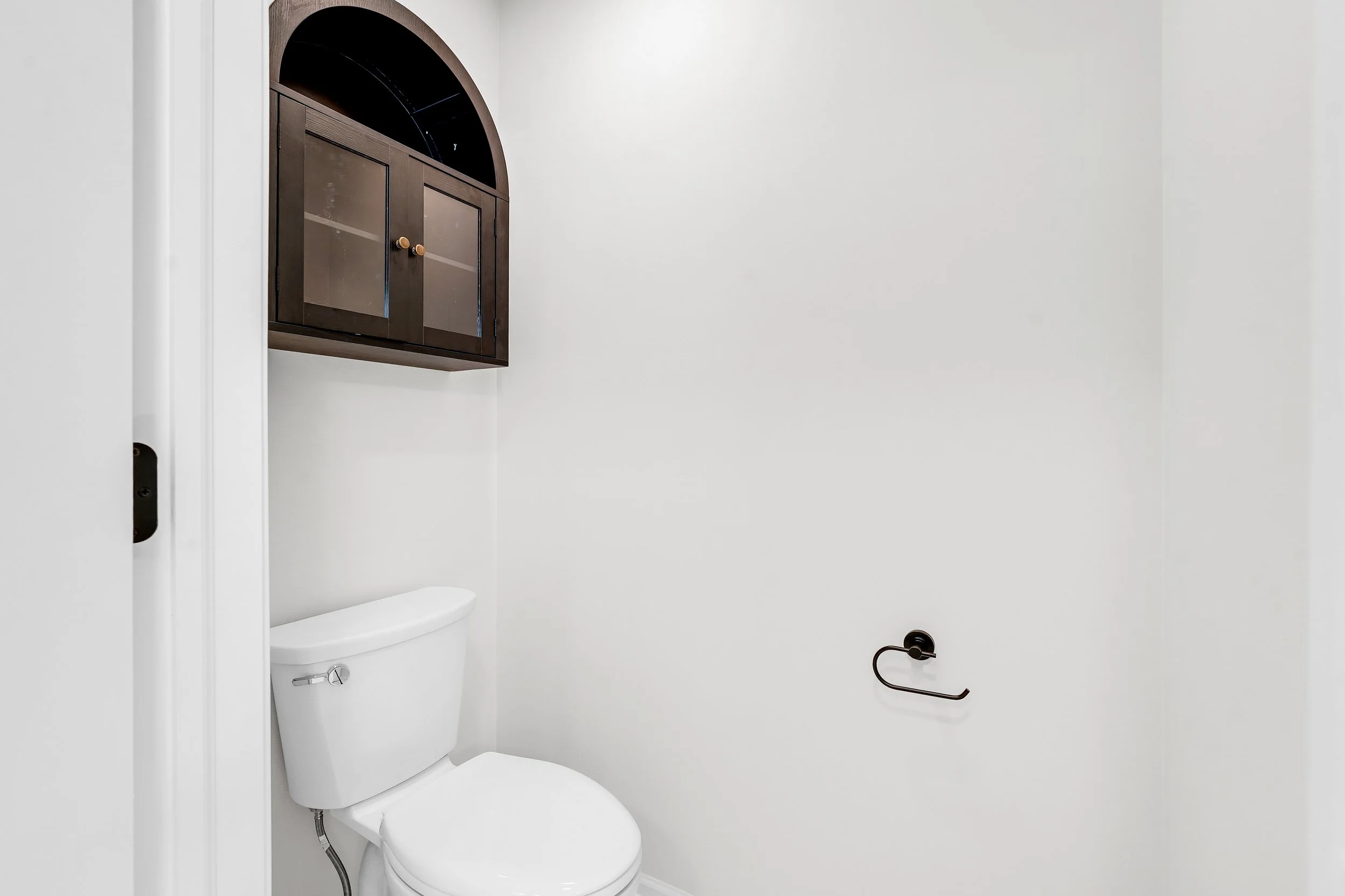 Water closet with above toilet storage cabinet