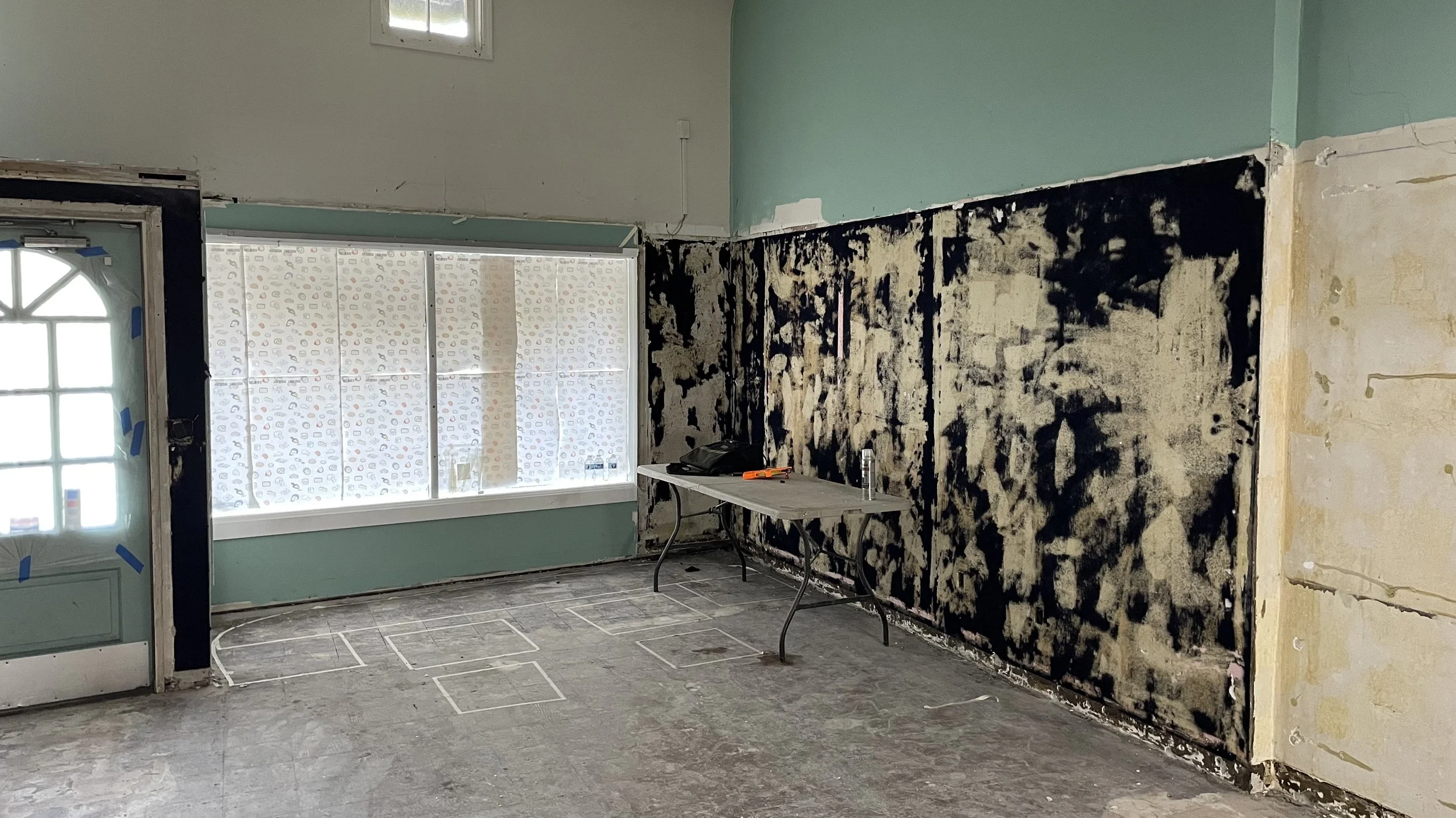 Mid construction of an empty retail storefront before renovation.